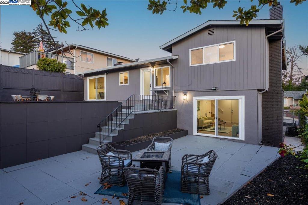 Escape to the serenity of the Oakland Hills with this stylishly reimagined split-level gem offering 4 bedrooms, 2.5 baths, and 1,922 sq ft of inviting interiors on a generous 6,000 sq ft lot. A welcoming facade sets the tone as you enter a light-filled living room, framed by a large picture window and cozy fireplace. Thoughtfully designed for easy living and entertaining, the open-concept layout flows effortlessly to the backyard from both the living and dining spaces. The sleek, modern kitchen is a culinary haven with a sunlit breakfast nook, wine bar, and seamless access to the patio. Upstairs, the serene primary suite features its own private bath, while three more bedrooms and a hallway bathroom complete the level. Downstairs, a flexible bonus room (perfect as a fifth bedroom or media room) offers its own fireplace, half bath, and laundry zone. The landscaped backyard delivers the ideal setting for alfresco dining or laid-back weekends. A wide driveway and attached garage enhance day-to-day ease. Moments from Highway 580/13, the Oakland Zoo, and East Bay’s best parks and trails—this inviting retreat blends tranquil hillside living with everyday convenience.