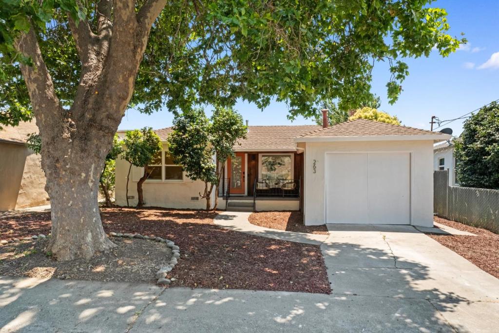 Welcome to 263 Ano Avenue, a thoughtfully remodeled single-level home blending modern comforts with warm design details. Natural light floods the open-concept living area, where white oak-style plank flooring, smooth walls, recessed lights, and a bold orange front door create a cheerful welcome. The kitchen features sleek two-tone cabinetry with soft close, undermount stainless steel sink with accessories and dual-action spout/extendable rain faucet, white quartz countertops, and a breakfast bar with natural wood accents. All NEW kitchen appliances include extra wide stainless steel refrigerator/freezer, dishwasher, induction range top and oven. Wide bi-folding doors extend the living space seamlessly to a newly built deck and a private backyard with new fence, ideal for entertaining or relaxing under the trees. Two large stylish bedrooms share a contemporary bath with gold-tone updated finishes such as a rain-shower, dual-flush toilet, and large format tile. With a finished garage, new hot water heater, new wall heater, new dual-pane windows, new light fixtures and hardware throughout. Central location near parks, schools, and The Bay, this move-in-ready home offers a perfect mix of function, charm, and investment value. Don't miss this San Lorenzo Village gem!