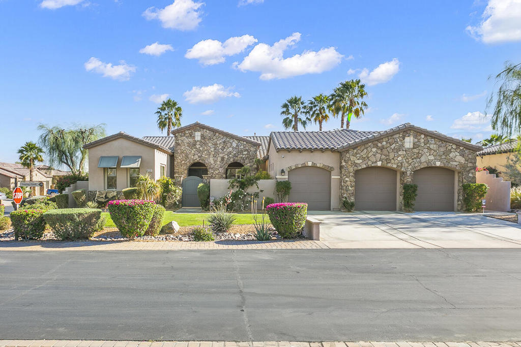 Tuscan-inspired resort home in Montage Santa Rosa, an STR-friendly gated community just minutes from world-class events. A gated courtyard opens to a grand foyer with soaring vaulted ceilings and statement chandeliers. The 4BD/3.5BA layout (plus den/office) balances elegance and function: formal dining with butler's pantry, and a chef's kitchen with double ovens, granite counters, walk-in pantry, and a generous breakfast nook flowing to a light-filled family room with 9' ceilings. Quality finishes include appliances/fixtures from Pacific Sales and tile/quartz selections from Arizona Tile. The south-facing backyard is an entertainer's dream with saltwater PebbleTec pool/spa and a large covered patio. Retreat-style primary suite offers two oversized walk-in closets, soaking tub, and walk-in shower. Major upgrades: dual Rheem 5-ton 16 SEER ACs & furnaces (2022), water heater (2024), pool heater/pump/control system (2017). Three-car garage with potential to convert one bay to an attached casita for added flexibility and income potential (buyer to verify). A compelling option for full-time living, a vacation retreat, or a high-performing STR.