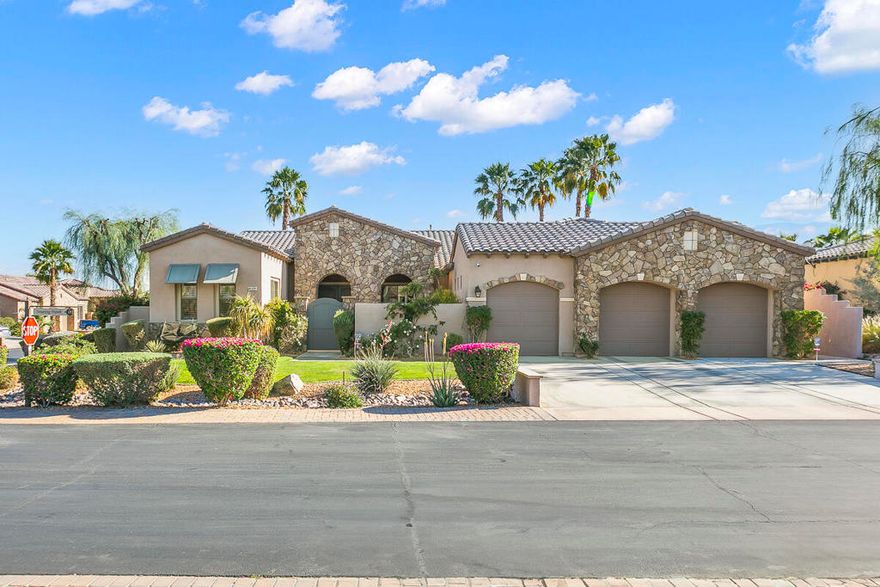 Tuscan-inspired resort home in Montage Santa Rosa, an STR-friendly gated community just minutes from world-class events. A gated courtyard opens to a grand foyer with soaring vaulted ceilings and statement chandeliers. The 4BD/3.5BA layout (plus den/office) balances elegance and function: formal dining with butler's pantry, and a chef's kitchen with double ovens, granite counters, walk-in pantry, and a generous breakfast nook flowing to a light-filled family room with 9' ceilings. Quality finishes include appliances/fixtures from Pacific Sales and tile/quartz selections from Arizona Tile. The south-facing backyard is an entertainer's dream with saltwater PebbleTec pool/spa and a large covered patio. Retreat-style primary suite offers two oversized walk-in closets, soaking tub, and walk-in shower. Major upgrades: dual Rheem 5-ton 16 SEER ACs & furnaces (2022), water heater (2024), pool heater/pump/control system (2017). Three-car garage with potential to convert one bay to an attached casita for added flexibility and income potential (buyer to verify). A compelling option for full-time living, a vacation retreat, or a high-performing STR.