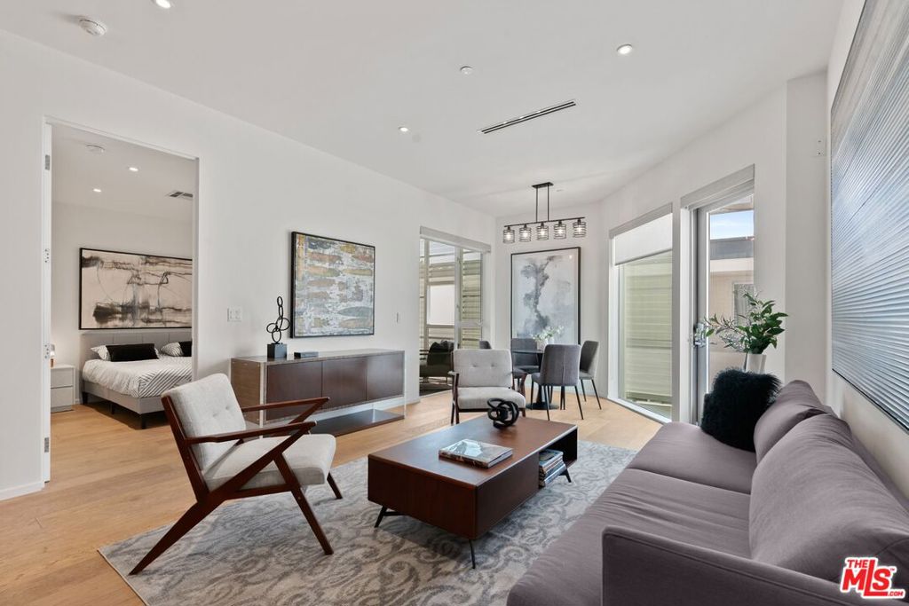 Architectural Edge & Exceptional Value in Prime West Hollywood. Stunning 2-bedroom, 2-bathroom offering standout design, luxury finishes, and SERIOUS value for newer construction in the heart of West Hollywood. In a market where cookie-cutter condos prevail, this residence stands out. Designed by an award-winning architect with interiors by MLH Design Group, the building boasts a bold architectural identity that sets it apart from the rest. Inside, 10-foot ceilings and oversized windows flood the space with natural light, while the open layout is equal parts smart and stylish. The sleek chef's kitchen features high-end Miele appliances, a movable center island, and Bauformat raw wood cabinetry. The generous primary suite includes a spa-like marble bath, designer details, and a walk-in closet with custom barn doors. Enjoy indoor-outdoor living with your own private terrace, perfect for lounging or entertaining. Building amenities include a fully equipped gym, secured entry, extra storage, tandem parking, bike storage, and two rooftop lounges with knockout Hollywood Hills views. Just off Santa Monica Boulevard, close to West Hollywood's top dining, shopping, and nightlife. For those seeking something that feels custom, not generic, this condo offers a rare blend of style, location, and value that you won't easily find elsewhere.