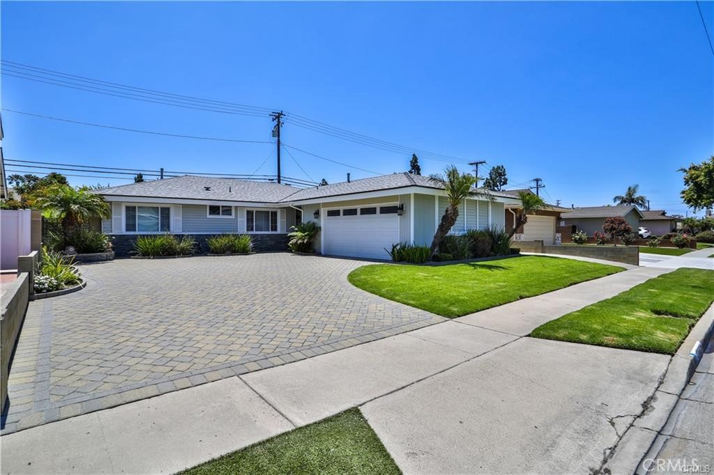 This 4-bedroom, 2-bathroom single-level home offers 1,539 square feet of comfortable living space. Freshly painted interiors and brand-new carpet complement the home’s hard-surface flooring. The open layout seamlessly connects the kitchen, dining, and living areas, anchored by a brick fireplace. The primary suite includes a private bathroom, while the three additional bedrooms have ample closet space and share an upgraded full bath with a shower and tub combination. Outside, a covered patio overlooks a large grassy yard with professional landscaping, perfect for relaxing or entertaining. An attached two-car garage with washer and dryer hookups adds convenience.