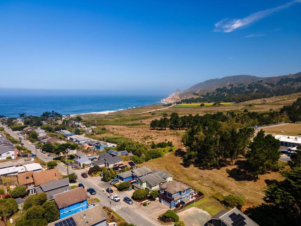 Welcome to this impressive custom-built 3-bedroom 2.5-bathroom home in the coastal town of Montara. Spanning approximately 1750 square feet, this high-quality residence offers a harmonious blend of craftsmanship, comfort, and natural beauty. Step inside to discover radiant heated travertine floors on the lower level, complemented by elegant curved plaster walls and a cozy gas fireplace. The kitchen features stainless steel appliances, granite countertops, and rich cherry wood cabinetry, all bathed in abundant natural light. A striking curved cherry wood staircase leads to the upper level, where you'll find three spacious bedrooms. The primary suite boasts vaulted ceilings, curved architectural walls, and a luxurious bathroom with a green slate shower, an oversized jetted tub, and walk-in closet. Outside, enjoy ocean views from your private backyard oasis, complete with a gas stone fire pit perfect for relaxing or entertaining under the stars. Just a short walk from Montara State Beach, scenic hiking trails on Montara Mountain, and historic Pt Montara Lighthouse. This home offers easy access to Hwy 1 and a short commute to San Francisco, Silicon Valley, and SFO. Don't miss this rare opportunity to own a thoughtfully designed coastal home in one of the most picturesque communities.