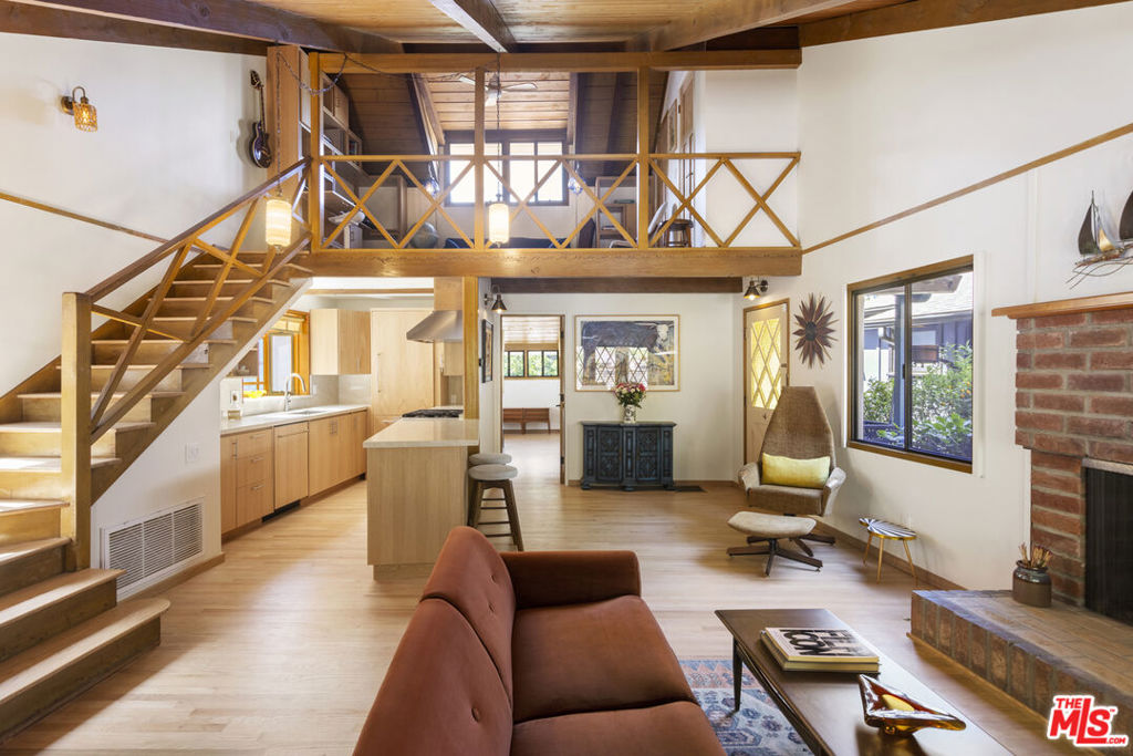 La Maison Bleue..Tucked near the top of iconic Wonderland Avenue, in a celebrity enclave within the magical Laurel Canyon community, this 1956 Storybook Cottage has been thoughtfully remodeled to suit contemporary living while honoring its original charm. Warm, soft, and grounded in neutral tones, this home radiates tranquility. One must see in person to truly feel the magic. The brand-new kitchen is a chef's dream, featuring high-end appliances, handmade custom White Oak cabinetry, and stunning Taj Mahal quartz countertops. Solid Oak floors flow seamlessly throughout the home. The primary bedroom includes a brand-new en-suite bathroom and a generous walk-in closet. A second full bathroom is conveniently located just off the living room. The laundry area, outfitted with a new LG Washtower system, is thoughtfully placed inside the home for ease and comfort. The second bedroom is a versatile loft space complete with a new closet and custom White Oak shelving units. It can easily be enclosed or enjoyed in its current open format, ideal as a guest room, office, or creative studio. Anchoring the living space is a striking brick fireplace wall, adding warmth and character. Step outside into a private Zen retreat: a blooming, auto-irrigated garden that's both enchanting and easy to maintain. At the top of the garden, a whimsical He/She Shed invites imagination and inspiration. Additional features include copper plumbing throughout, a brand-new 200-amp electrical panel, one-car garage, and a generous 2+ car driveway. This single-family residence offers the rare charm of a canyon cottage with the price tag of a WEHO condo, completely turn-key and ready to move in. This home is gorgeous!