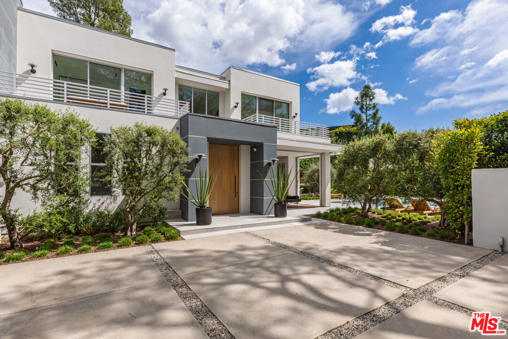 Property is still actively listed and on hold. Please do not contact sellers. Tucked away on prestigious Alto Cedro Drive, behind private gates and a large motor court, this exceptional Contemporary Beverly Hills estate boasts 6 bedrooms and 7.5 bathrooms, displaying sophistication and elegance. Completely renovated and thoughtfully expanded in 2022, this home showcases the finest materials, from rich oak wood to luxurious marble, each space radiating timeless elegance and meticulous craftsmanship. Skylights and expansive windows flood the home with natural light, framing peaceful views. The grand front door opens into spacious formal dining and living areas with a striking architectural fireplace and pocket doors that open to lush greenery and a sparkling pool with spa. The adjoining open-concept family room and gourmet kitchen create an ideal space for both relaxation and entertainment, with Calcutta marble countertops, a spacious island and top-of-the-line appliances. Pocket doors lead to an alfresco dining area, blending indoor and outdoor living. The lower level has a private office with an ensuite bathroom and three spacious guest suites, each with soaring ceilings and oversized windows. Floating stairs lead to the sumptuous primary suite with a sitting room, terrace, panoramic views and a spa-like bathroom suite with marble and wood finishes, oversized shower and a soaking tub. The bespoke walk-in closet offers unparalleled luxury and organization. The upper level also includes a private theatre room with seating for four, two additional guest bedroom suites and a dedicated full gym for health and wellness. The tranquil grounds offer a serene escape with a poolside fire pit, lush lounge areas, fruit trees, and mature trees. A Zen-inspired pavilion with water feature provides an idyllic spot for dining and quiet reflection. Additional luxurious amenities include a 2-car garage, Savant integrated smart home system, Oxygen Ozone whole-house water filtration with additional drinking system, custom wine storage, utility rooms on both levels, ample storage, two electric charging stations, a solar panel system and a backup generator. More than just a home, Alto Cedro offers an elevated lifestyle that harmoniously blends indoor and outdoor living, embodying the essence of the ultimate Southern California experience.
