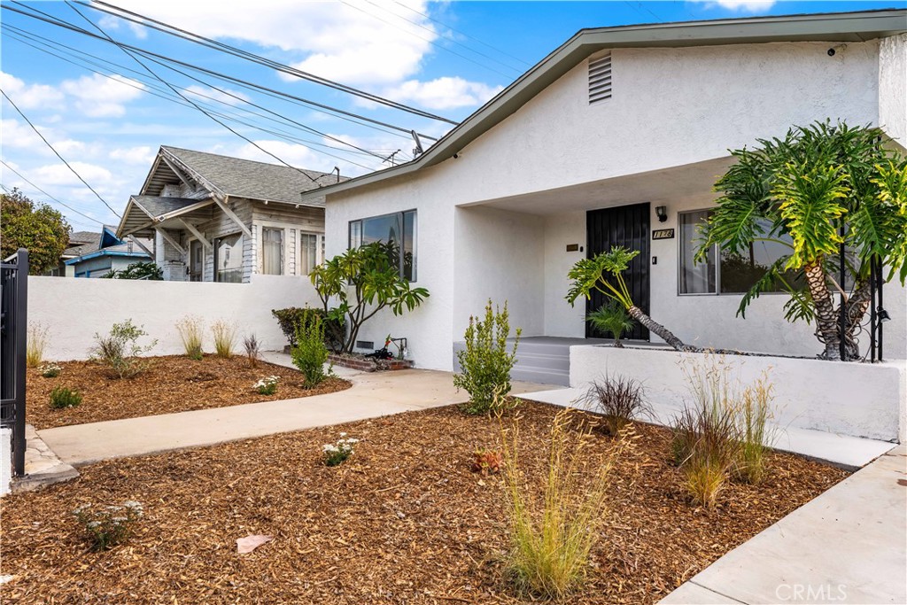 This isn't your typical Boyle Heights home. Set in the heart of Boyle Heights, this light-filled 3-bedroom home blends vintage character with thoughtful updates and a warm, welcoming spirit. Behind a gated front yard framed by lush greenery, the home opens to a bright, open concept living space with soaring 9' ceilings and original charm intact. Through the wooden front door with amber stained glass, you’re greeted by a spacious living room drenched in natural light from four windows, including a picture window overlooking a plant filled front porch. Adjacent to the living area, a sunroom with a large window offers flexible use as a den, office, or guest space, perfect for working from home or hosting friends. The freshly remodeled bathroom features a new shower with sparkling white tile and chrome accents, and new tile floors creating a spa-like retreat filled with soft, natural light. The kitchen has been updated with new recessed lighting and easy access to a generous laundry room that connects to the backyard. Each bedroom feels airy and bright, with the primary bedroom opening directly to the garden, a peaceful spot to enjoy morning coffee among the fig and bougainvillea. Outdoors, the large, level backyard is a private sanctuary framed by mature fruit trees, roses, and vibrant blooms. The detached garage, formerly an artist’s studio, offers endless possibilities as a creative workspace, home office, or guest retreat. Ideally located minutes from Downtown LA and the Arts District, this Boyle Heights gem offers the perfect balance of privacy, light, and urban convenience. A home filled with heart and history, ready to inspire its next chapter.
