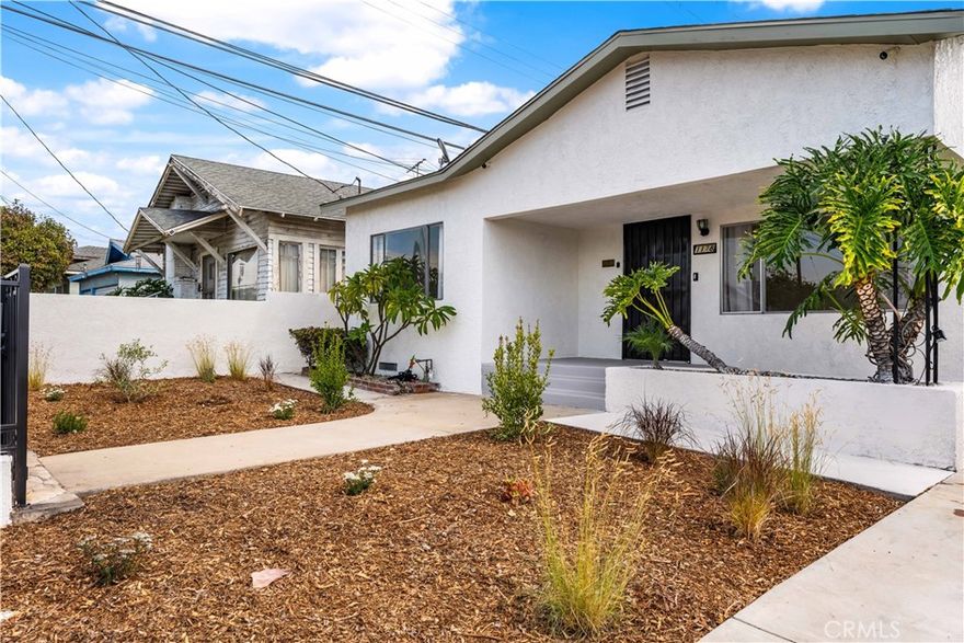 This isn't your typical Boyle Heights home. Set in the heart of Boyle Heights, this light-filled 3-bedroom home blends vintage character with thoughtful updates and a warm, welcoming spirit. Behind a gated front yard framed by lush greenery, the home opens to a bright, open concept living space with soaring 9' ceilings and original charm intact. Through the wooden front door with amber stained glass, you’re greeted by a spacious living room drenched in natural light from four windows, including a picture window overlooking a plant filled front porch. Adjacent to the living area, a sunroom with a large window offers flexible use as a den, office, or guest space, perfect for working from home or hosting friends. The freshly remodeled bathroom features a new shower with sparkling white tile and chrome accents, and new tile floors creating a spa-like retreat filled with soft, natural light. The kitchen has been updated with new recessed lighting and easy access to a generous laundry room that connects to the backyard. Each bedroom feels airy and bright, with the primary bedroom opening directly to the garden, a peaceful spot to enjoy morning coffee among the fig and bougainvillea. Outdoors, the large, level backyard is a private sanctuary framed by mature fruit trees, roses, and vibrant blooms. The detached garage, formerly an artist’s studio, offers endless possibilities as a creative workspace, home office, or guest retreat. Ideally located minutes from Downtown LA and the Arts District, this Boyle Heights gem offers the perfect balance of privacy, light, and urban convenience. A home filled with heart and history, ready to inspire its next chapter.