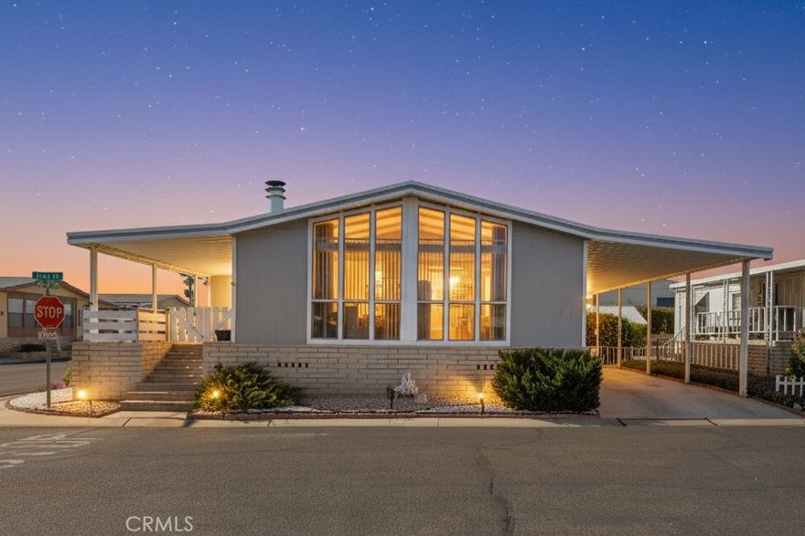 Welcome home to this beautiful updated 2-bedrooms, 2-bath triple-wide corner lot mobile home offering over 1,800 sq.ft of comfortable living space! Step inside to discover new flooring, freshly painted interior and exterior, and a bright open layout perfect for entertaining. The kitchen features freshly painted cabinets and a new light fixture, opening to a cozy wet bar and dining area. Enjoy the convenience of a laundry room with built-in cabinets and plenty of storage throughout. Both bathrooms have been upgraded with new sinks and mirrors, while the large primary suite boasts new carpet, a walk-in closet, and plenty of natural light. relax year round with central heating and air conditioning and upgraded front porch ideal for morning coffee or evening sunsets. Located in a desirable all ages community offering incredible amenities: pool, clubhouse, library, kitchen, dog park, BBQ area, and pickleball court, this home truly has it all. Move-In ready. Won't last long! Schedule your private showing today!