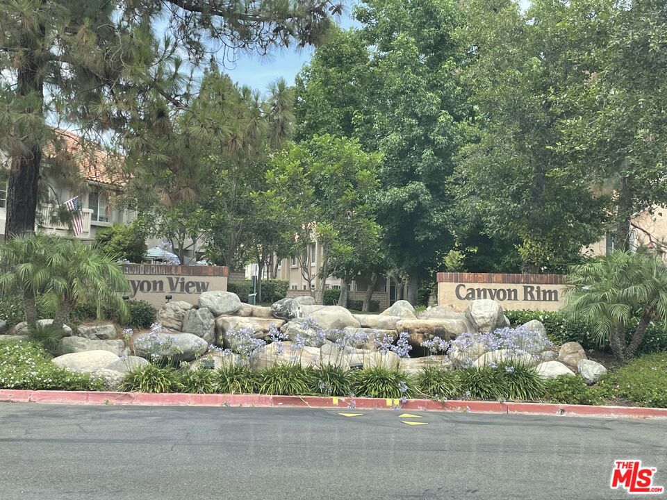 Stunning 2 Bed, 2 Bath Condo with Canyon Views & Unique Outdoor Space! Welcome to your new home! This beautifully maintained 2-bedroom, 2-full bathroom condo offers the perfect blend of comfort, style, and rare outdoor space. Featuring laminate and tile flooring throughout, this home boasts a warm, modern aesthetic with low-maintenance living. Enjoy the convenience of two single-car garages, one attached directly to the unit and a second detached for added flexibility and storage. Step outside to your private, oversized front yard area, a rare find in this community ideal for relaxing, gardening, or entertaining guests. From your front windows and yard, take in the serene canyon tree views that offer a peaceful, nature-filled backdrop rarely found in condo living. Don't miss your chance to own one of the few units in the neighborhood with this combination of natural beauty, spacious outdoor living, and dual garages. This is more than a condo, it's a lifestyle.