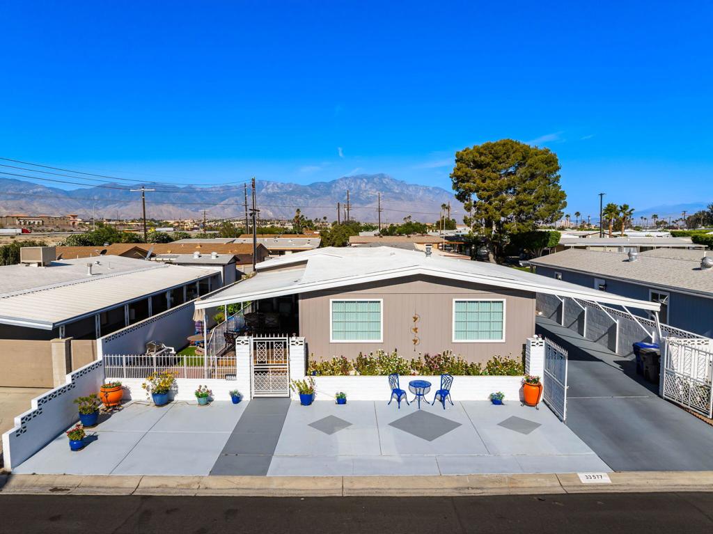 Welcome to Tri-Palms Country Club, a vibrant 55+ golf course community where you own the land--and this charming 2 bed, 2 bath home is 433A certified! This double-wide with an additional bump out offers an open layout and thoughtful upgrades including new luxury vinyl plank flooring, dual-pane windows, drywall throughout and wood siding for added curb appeal.The remodeled kitchen shines with quartz countertops, cabinet pull-outs, and stainless appliances. The primary bedroom features a massive walk-in closet, and the attached golf cart garage doubles as a spacious shed, workshop or storage area. Relax on the tiled patio with peek-a-boo golf course views, or take full advantage of the incredible community amenities: three pools, two hot tubs, putting green, tennis, pickleball, shuffleboard, clubhouse, restaurant/bar, horseshoes, card room, library, dog park, and a packed social calendar.As a bonus, two deeded owners of record receive unlimited golf on two golf courses. Whether you're looking for full-time living or a seasonal getaway, this home is a fantastic find in one of the desert's most affordable and amenity-rich communities!