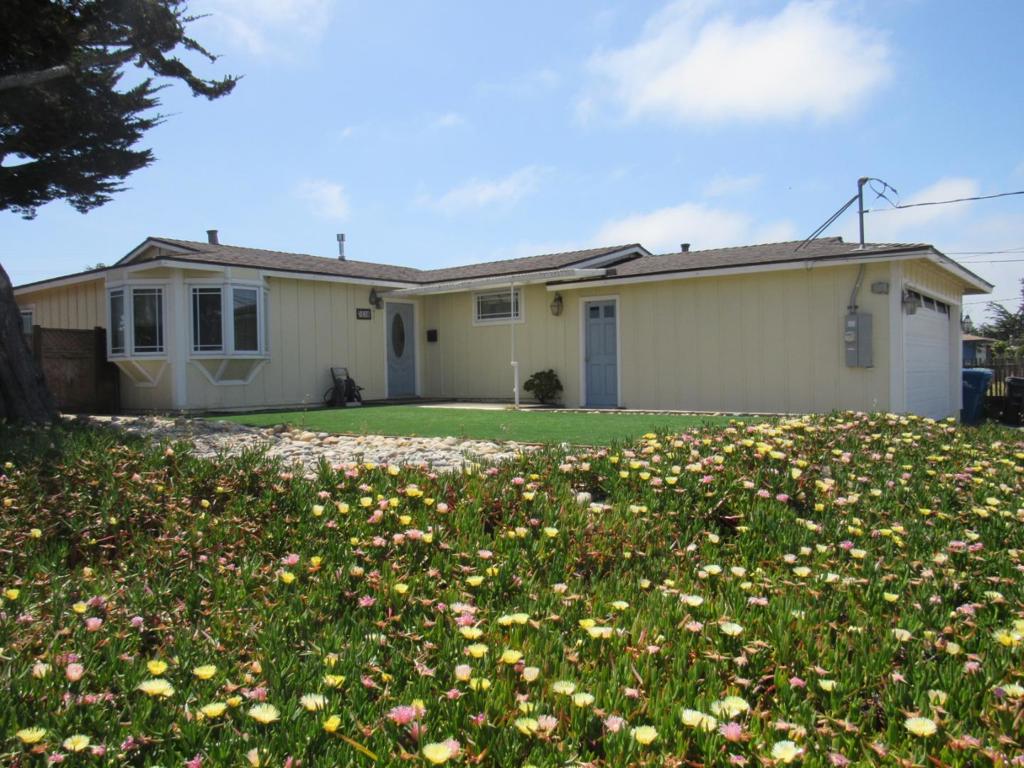 Welcome to this charming home located in an established neighborhood in Marina. This residence offers a comfortable living space with 1,143 square feet, featuring three bedrooms and a full bathroom with a shower over tub. The front yard is low maintenance with artificial turf and drought tolerant plants. As you enter the Living Room is to the left and 1 Bedroom to the right. The cozy living room with a Bay Window and plenty of windows to let the afternoon sunlight in. The dining area is off the living room and adjacent to the kitchen. The heart of the home is the well-appointed kitchen, complete with modern amenities such as a dishwasher, new gas stove, garbage disposal, stainless steel refrigerator and microwave, making meal preparation a breeze. Enjoy cozy moments in the living room, and dining area, perfect for gatherings. The luxury vinyl flooring throughout the house provides style and comfort. Additional features include convenient laundry facilities in the garage and a spacious two-car garage. The property also boasts energy-efficient features like low flow toilets. Situated within the Monterey Peninsula Unified School District, this home is ideally located for families. With no cooling system, the home relies on central forced air gas heating for temperature control.