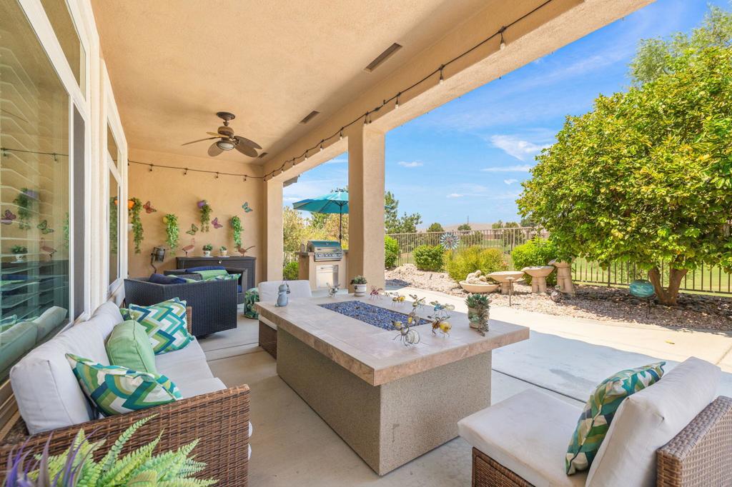 Priced below Appraisal dated Aug 2025- Sellers moving out of State, Great opportunity on this expanded Victoria model. The open floor plan seamlessly connects the living and dining areas, providing an ideal setting for both relaxation and entertaining. Complete with fireplace for chilly Desert nights , Bose surround sound system , formal dining area and slider access to backyard entertaining area. The kitchen is a chef's dream, featuring granite countertops, dining style island, plenty of storage, and a cozy breakfast nook, perfect for casual dining or morning coffee.The property boasts three spacious bedrooms and two and a half luxurious bathrooms, including a convenient powder room for guests. The Primary suite offers a tranquil retreat with bay window and ample space for relaxation. Primary ensuite with dual sink vanities, remodeled shower and separate soaking tub with spacious walk in closet. Two additional generous sized bedrooms both with deep mini walk in closets and direct access to Jack and Jill full bath. Interior laundry room with sink located between kitchen and garage. Double oversize garage with Swiss Trax flooring for cooling and ease of care. Beautiful hardwood and tile floors throughout with the exception of one guest bedroom with premium wood plank flooring that blends like a dream. Plantation shutters throughout, ceiling fans, recessed lighting, upgraded dual pane windows throughout and exterior painted Jan. 2025.Step outside and revel in your outdoor living space complete with extended patio, mist system and built in BBQ. Soak in the starry nights, the colorful north mountain sunsets, golfers on the driving range. Completely fenced so your dogs and grandkids can enjoy it too! Sun City is the ultimate community with multiple clubhouses, restaurants, fitness center, indoor and outdoor pools and spas, 2 Championship Golf courses, driving range, putting range, Pickleball, tennis, bocce courts, Library, Theater, Ballroom, onsite post office, coffee bar, dog park, softball field, plus approx. 80 clubs to join! Why would you want to leave? But if you do - close proximity to dining, shopping , medical , the Acrisure Arena - let's chat , these Sellers have VIP membership for our Firebirds for balance of this year and 2026. Let's make a deal! Must see home, you won't be disappointed!