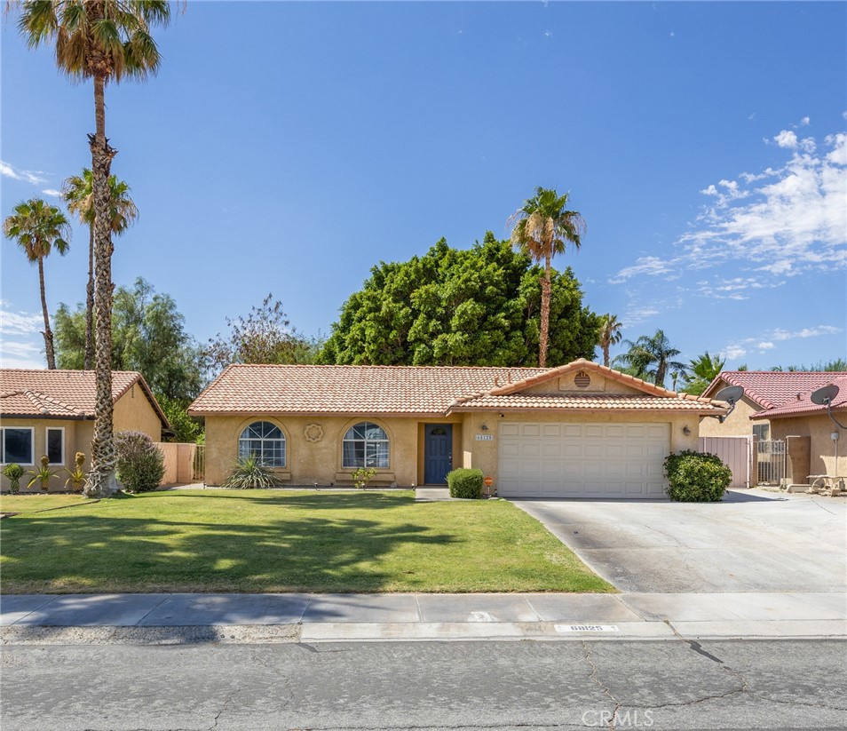 Well-maintained 3-bedroom, 2-bath single-story home located in the sought-after Panorama Park neighborhood of Cathedral City. This inviting residence features an open-concept living area with vaulted ceilings and a cozy gas fireplace, along with a spacious kitchen equipped with granite countertops, ample cabinet space, and French doors leading to a large backyard—ideal for indoor-outdoor living. The primary suite includes a walk-in closet, en-suite bath with tub/shower combo, and direct access to a full-length covered patio. Two additional bedrooms and a full guest bath provide comfortable accommodations. The finished two-car garage includes laundry hookups and extra storage. The expansive backyard is fully fenced and offers mature landscaping, outdoor dining space, and gated RV parking. No HOA. Conveniently located near parks, schools, and shopping.