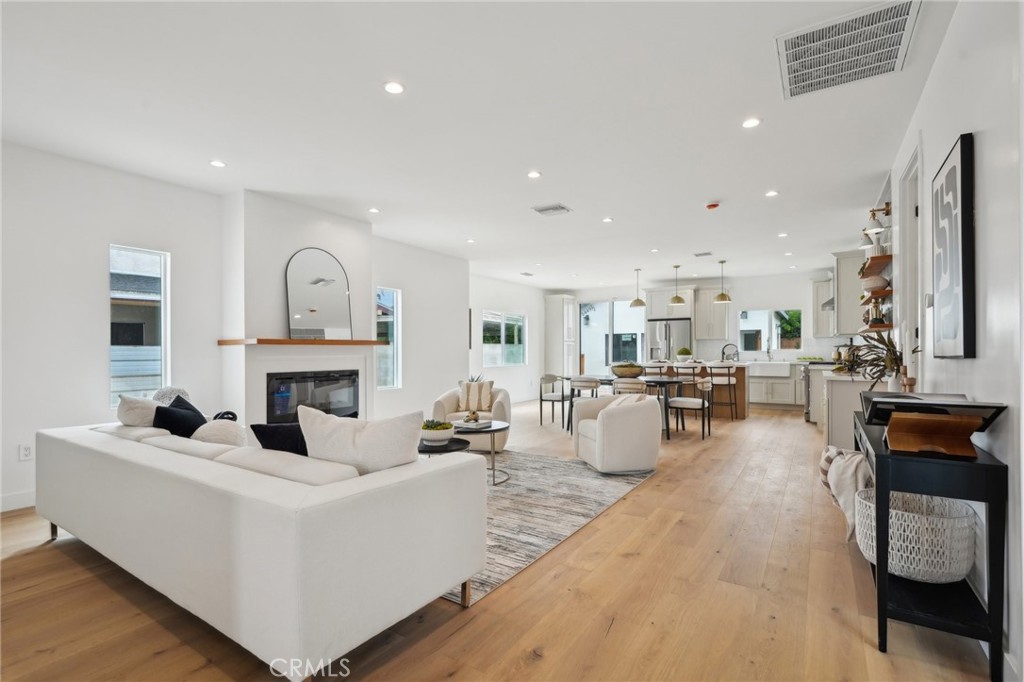 Completely renovated from top to bottom, this 3-bedroom, 2-bathroom residence with modern upgrades, including new windows, electrical, plumbing, HVAC system, and main sewer line. The open-concept living space features a bright and airy design with a spacious kitchen with quartz countertops, a breakfast area, and new stainless steel appliances, including a stove, oven, refrigerator, and dishwasher. A bonus area provides the perfect space for a home office, adding flexibility to the layout. Enjoy your mornings or entertain guests on the expansive deck, accessible from both the kitchen and the primary suite, while overlooking the beautifully landscaped backyard with a new sprinkler system. Additional upgrades include a brand-new tankless water heater for maximum efficiency. Adding incredible value to this property is the newly built 1-bedroom, 1-bathroom Accessory Dwelling Unit (ADU) at 5449 1/2 S Victoria Ave. This designed space boasts a modern kitchen with quartz countertops and new stainless steel appliances, including a stove, microwave and refrigerator. The living area, in-unit laundry, and brand-new electrical, plumbing, windows, and mini split make this ADU completely move-in ready. Like the main home, it also features new wide-plank engineered flooring throughout. Whether you're looking for a rental income opportunity, guest house, or additional living space. This home is within walking distance to the Crenshaw metro line and popular shops and eateries like Jon & Vinny's and just minutes from Kenneth Hahn State Park, SoFi Stadium/Hollywood Park, Culver City, Playa Vista, DTLA,Silicon Beach, and LAX. This property is truly an entertainer's dream and a fantastic investment opportunity, providing both a luxurious home and an income-generating unit. Don't miss out on this rare find.