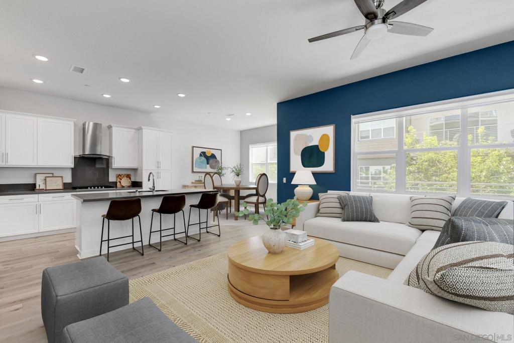 Experience the feel of a modern penthouse in this rare corner-lot Millenia build (2020). What sets this upscale residence apart is the first-floor private-entry Junior ADU — complete with living area, kitchenette, full-sized laundry, large bedroom, and bath (ADA compliant). Perfect for multi-generational living, mortgage offset, private studio/office, or nanny/maid’s quarters — the possibilities are endless.Designed to impress the most selective buyers, this home showcases thoughtful, quality finishes throughout. The primary suite offers two walk-in closets and a spa-like soaking tub, while the upper level features two additional full-sized bedrooms and bathrooms. Enjoy an unmatched lifestyle in a walkable community surrounded by top-rated schools, neighborhood parks, shopping, dog-friendly spaces, and fine dining including Paris Baguette and local bistros. Built to last and located in one of Chula Vista’s most desirable neighborhoods, this home is both a rare opportunity and a sound investment in long-term value.