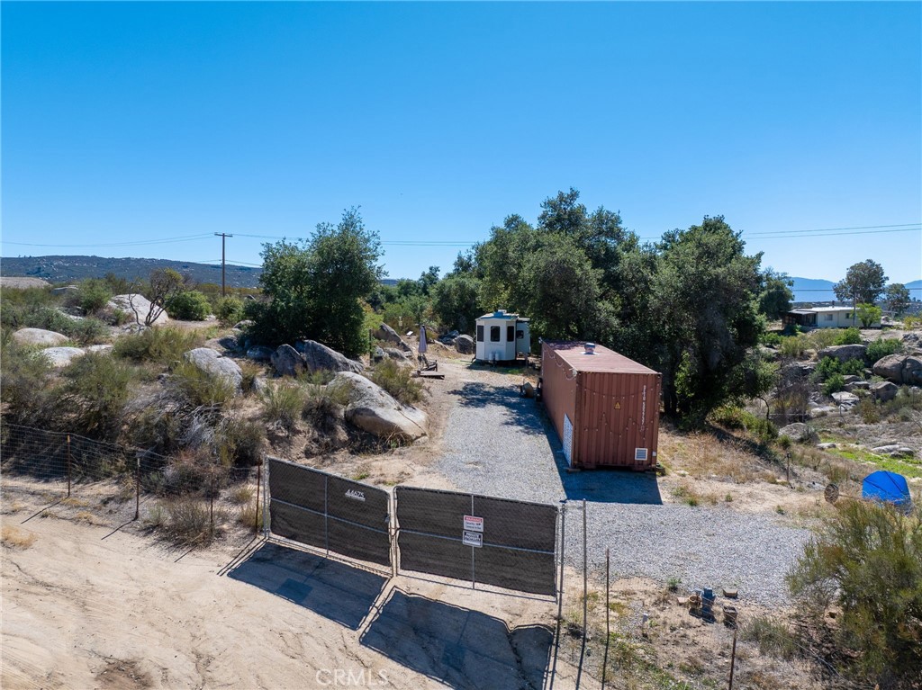 Discover a rare opportunity to own a secluded slice of California, complete with essential infrastructure already in place. This serene and private 5.01-acre parcel offers a harmonious blend of natural beauty and practical readiness for development or immediate use. The property is equipped with electricity, water, and a septic system, making it ideal for a private retreat, sustainable homestead, or a distinctive development project.
Included at no additional cost are valuable on-site assets: a move-in ready 40-foot trailer and a shipping container perfect for secure storage or creative repurposing. The land features two wells, two water storage tanks, and underground plumbing for irrigating garden areas. Power hookups are available for trailers or future structures, and the parcel is zoned for rural residential use, perfect for building a custom home, placing a mobile home, or creating a horse property. Surrounded by oak trees, horse trails, and stunning mountain views, this property offers peaceful seclusion just minutes from town.