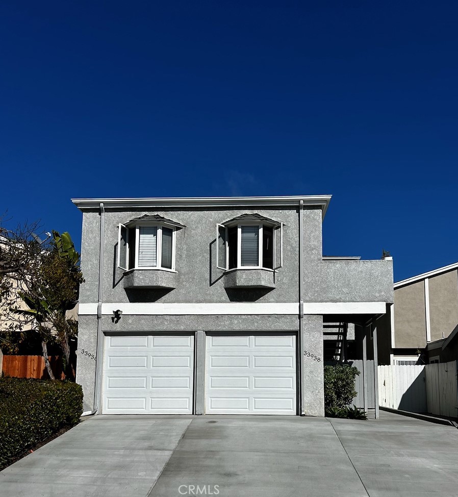 ALL Utilities are Included in RENT, no pets. Gated walkway leads to front door and large beautifully landscaped private patio,
Slider off living room with windows going up from there to a lofted ceiling brings in all the light. Step down to dining and kitchen area with porcelain tile flooring that will last forever. In the kitchen newer dark wood cabinets, granite counters, gas range, dishwasher, fridge included. Pantry and 1/2 bath in hallway leads to attached 1 car garage with opener, washer hookup, gas dryer hookup, additional assigned parking in spot driveway. Near front door is a large coat closet with accordion doors, and stairway. Two tone paint in bedrooms, dual pane windows, mirrored wardrobes, dual sinks, shower over tub in jack and jill bathroom. Plenty of storage in linen closets, brand new gas furnace upstairs, and new water heater in garage. Many single family homes on this portion of the street above La Cresta. Short walk to the up and coming Lantern District, and many ocean view parks and trails along the bluff overlooking Dana Point Harbor, and Doheny State Beach.