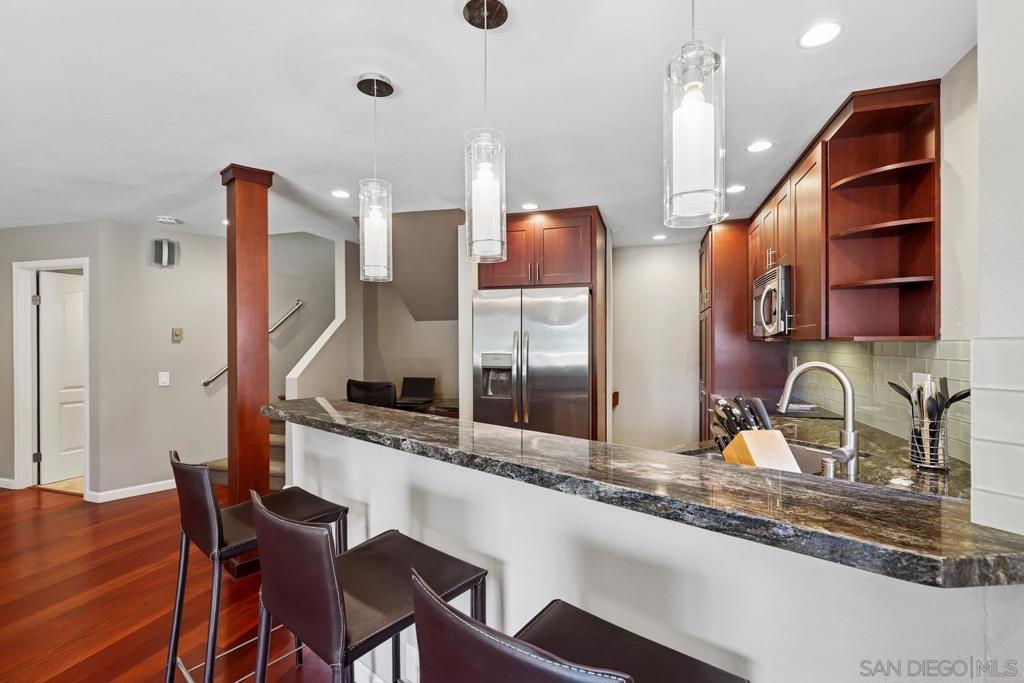Discover the highly sought-after Woodlands West community in La Jolla Village, perfectly situated west of the 5 freeway and just moments from UCSD, La Jolla Shores, top schools, and premier shopping and dining. This spacious two-story townhome offers direct access with an attached two-car garage and is surrounded by lush greenbelts with access to resort-style amenities, including a pool, tennis courts, and clubhouse. Inside, the light-filled floor plan features wood flooring, recessed lighting, and a welcoming fireplace that anchors the living area. The beautifully remodeled kitchen is highlighted by granite countertops, stainless steel appliances, and rich cabinetry, with a convenient breakfast bar connecting seamlessly to the dining and living spaces. A built-in office nook adds flexibility for today’s lifestyle. Step outside to your own large private patio, ideal for entertaining or quiet relaxation. Upstairs, the generous primary suite impresses with vaulted ceilings, a private balcony, ample closet space, and a stylish en-suite bath. A junior suite with its own bathroom provides comfort for guests or family. This residence combines style, convenience, and a coastal lifestyle in one of La Jolla’s most desirable neighborhoods.