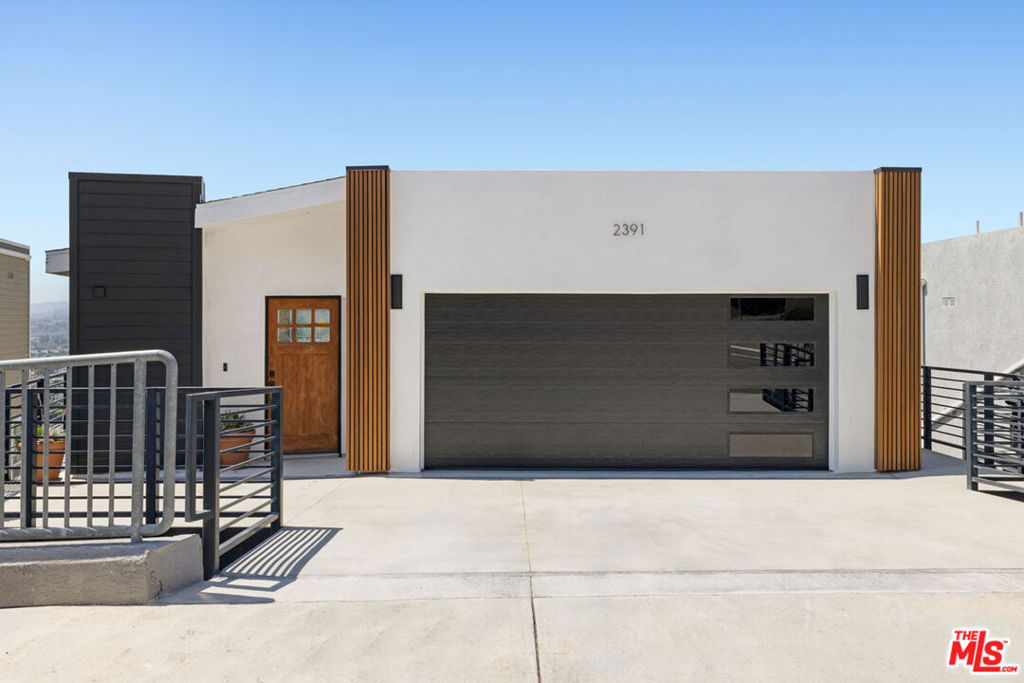 In Glassell Park, this modern residence delivers expansive living, cinematic vistas, and a versatile layout. The main level holds a light-filled living room with wood floors and glass sliders opening to the deck, a sunny spot for coffee or meals with scenic views. The open kitchen is finished with quartz counters, stainless appliances, a full backsplash, and generous storage. Downstairs, a second living room is a useful flex space for your office, den, or creative pursuits, also opening to a deck with views. Three bedrooms include a spacious primary with a beautifully appointed ensuite bath.Amenities include Nest HVAC, laundry, and a garage plus driveway parking. Local favorites Lemon Poppy Kitchen, Bub and Grandma's, The Dunsmoor, and The Grant are nearby, along with all the excitement of neighboring Highland Park.