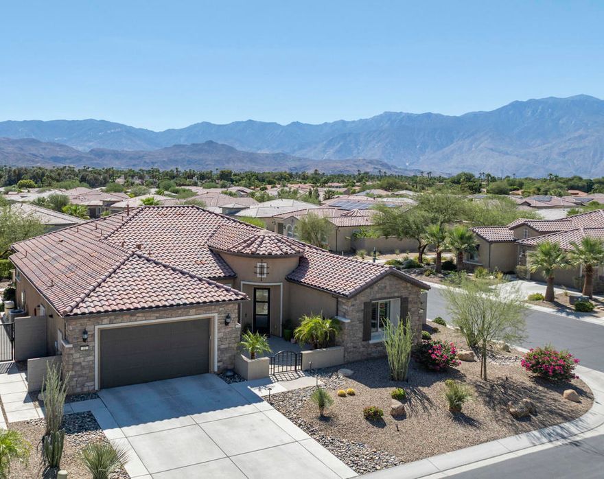 BEST VIEW AT DEL WEBB! Welcome to this stunning SERENITY model with OWNED SOLAR and situated on an elevated corner lot to capture panoramic MOUNTAIN VIEWS. Featuring high ceilings and walls of glass, the home exudes luxury the minute you step into the rotunda foyer from the courtyard. The open floor plan centers on a sleek kitchen with KitchenAid appliances, granite countertops and an expansive island that flows into the living area with a MULTI PANEL SLIDING DOOR SYSTEM opening to a resort style backyard for true indoor/outdoor living. Enjoy the sparkling PebbleTec pool and spa plus side patio with pergola for BBQ and al fresco dining. Two private ensuites are well separated for privacy and the luxurious primary suite with spa like bath and custom walk-in closet opens to the pool and fabulous mountain views. The office/den with french doors and custom built-ins can also be used for a third sleeping space. Conveniences include a wine fridge, laundry room with sink and the garage features a built-in workshop, lots of storage, a water softener, tankless water heater plus its own A/C unit and insulated garage walls/ceiling. With all the finest finishes and details, this home has been meticulously maintained and is ready for you to enjoy. Del Webb Rancho Mirage is the premier 55+ community with walking trails, incredible views and so convenient to upscale shopping and dining. Residents enjoy a low HOA fee that includes cable and internet, Clubhouse, pools, tennis courts, pickelball, putting green, fitness center and endless activities. Call today to schedule your private showing.