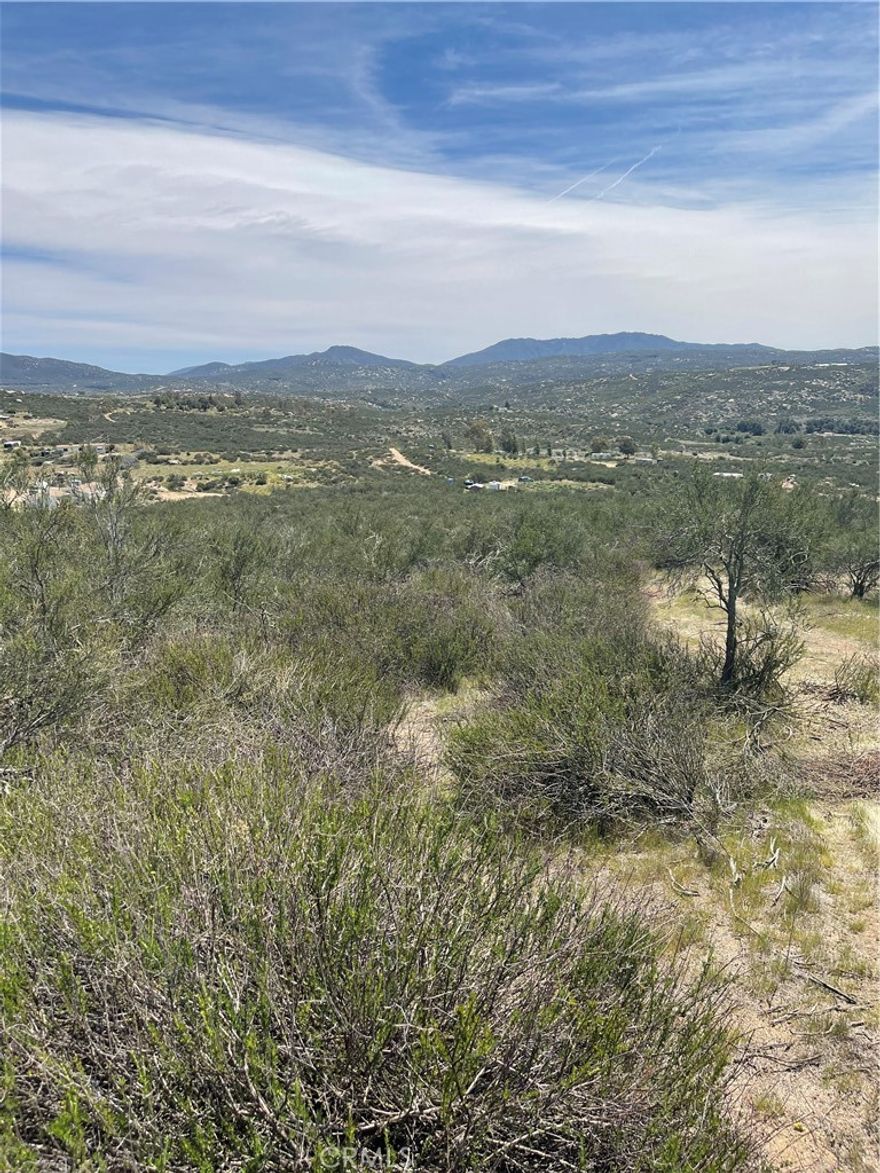 Gentle rolling 2.38 acre corner lot, perfect for custom/manufactured home with a view. Also great for investment.