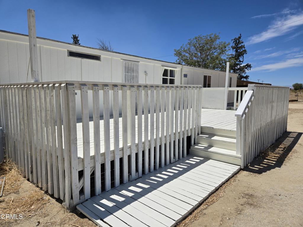 Opportunity is knocking right now!!! This is one of the best priced homes you will ever find. Live out in the country away from it all instead of impoverishing yourself with a huge home loan. Big and roomy home is on a cul-de-sac with 2.5 acres and views of the Tehachapi Mountains. Bring your animals, bring your work trucks, build a workshop. Privacy is the word. There is a huge deck for entertaining. New air conditioner, new roof, new carpet, remodeled bathroom, some new windows. There is a private well, septic installed and power is already to the property. You can live in the existing home while building your dream home or a Guest Home (ADU) for monthly income. You are away from it all while being around a five minute drive to town or the 14 freeway. This home is not on a permanent foundation but loans are available.