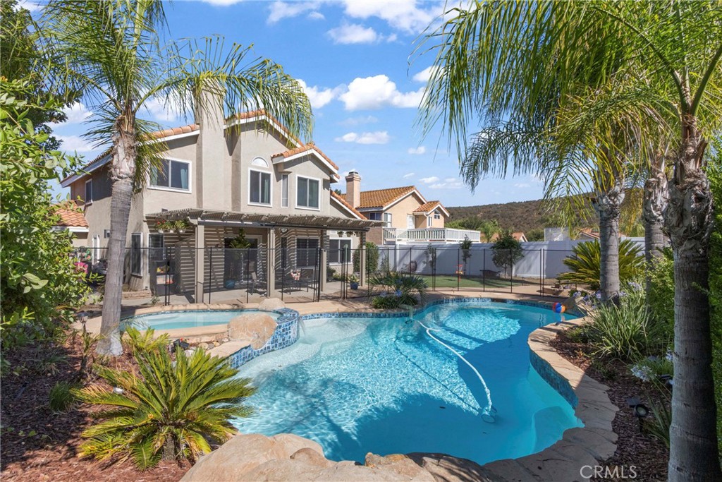This beautifully upgraded, turnkey pool home nestled on a quiet cul-de-sac in central Murrieta offers no HOA and low taxes! The spacious 4-bedroom, 3-bath home includes a highly desirable downstairs bedroom with its own private entrance and adjacent full bath, perfect for guests or multi-generational living. Step inside to soaring ceilings and a light-filled formal living room. Continue through to the kitchen featuring granite countertops, white cabinetry, newer stainless steel appliances, and a casual dining nook, plus a separate formal dining room for gatherings. The kitchen opens to the inviting family room with a cozy fireplace and sliding glass doors that lead to a private backyard retreat—complete with a resurfaced pool and spa, with new pool pump, new fence, new pool sweeper & new pool & spa lights. Backyard also includes a new alumawood patio cover, new turf lawn, firepit, and a variety of fruit trees including apricot, plum, apple, avocado, lemon, two orange trees, kumquat, and tangerine. Upstairs, you’ll find three additional bedrooms and 2 full baths, including the spacious primary suite with large windows, a ceiling fan, and a completely remodeled ensuite bathroom featuring a barn door, new walk-in shower, soaking tub, dual vanity, and updated counters. The primary suite also includes a generous walk-in closet. Additional upgrades throughout the home include crown molding downstairs, a whole house fan, new AC & HVAC system installed in July 2025, as well as new Anderson windows, updated ductwork, attic insulation, and a leased solar system for energy efficiency. A separate laundry room is conveniently located on the main level, and the 3-car garage offers ample space for vehicles and storage. Ideally situated just minutes from the 15 and 215 freeways, Clinton Keith Road, award-winning schools, shopping, and dining—this home truly has it all: location, comfort, and lifestyle!