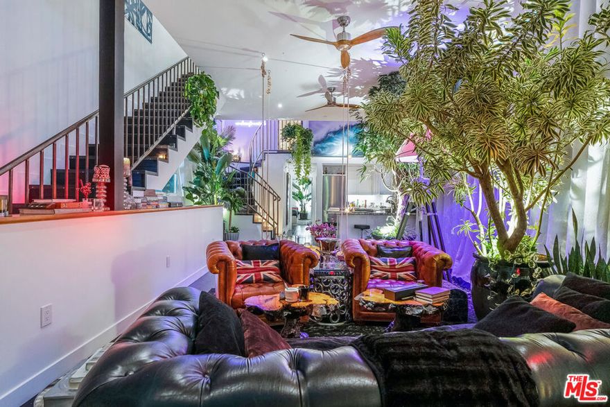 "The Venice Art House", a James Bond architectural fully gated property with rare LAC2 zoning and two addresses in the heart of Venice. Between Abbott Kinney Boulevard and Lincoln, this compound is fully secured and private. The property features 3 beds and 3 full baths, with a rooftop outdoor shower, spa, infrared sauna, and custom sound. 11ft ceilings in the LR on the 2nd floor reach to 14ft in the open-concept kitchen with a stone bar, gigantic double-paned glass windows in the LR to limit sound, and ceiling to floor elegant custom drapes in the LR and BR. Black hardwood floors throughout, adorned with Timothy Oulton furniture set with vintage appointments, Miele appliances, thick steel beams, and elgantly bent iron railings. The first level features a 4-car garage, and a separate open studio space with its own entry and gate, polished concrete floors, rainfall shower, and it's own AC, kitchenette and washer/dryer. The house was built with sought after durability, including images of the build, and full blueprints. The spacious master bedroom offers British design, a beautiful custom walk-in closet, custom blackout drapes and curtains, and a private balcony. A spiral staircase above the kitchen leads to a library-movie room with four skylights, including one in the upper bathroom with full shower. A separate staircase from the LR leads to the rooftop deck featuring custom finished teak wood, lush California succulents and panoramic views from the palm tress in MDR to the hills above Sunset. Sun or work in privacy between the spa, fireplace and outdoor shower while listening to orchestra music above the city. The revenue from the separate studio and media area can be retained, currently ranging from $4,000-6,000/mo, or the entire main house can be leased for an additional projected $14,000-$15,000/mo or on VRBO and other platforms for more. With incredible versatility with LAC2 zoning, the entire three story property could also be transformed into a restaurant, lounge, gym, retreat spa, or media studio with remarkable possibilities. This is one of the rarest gems in all of Venice, offering a unique blend of privacy and security while allowing you to fully enjoy life in the heart of Venice.