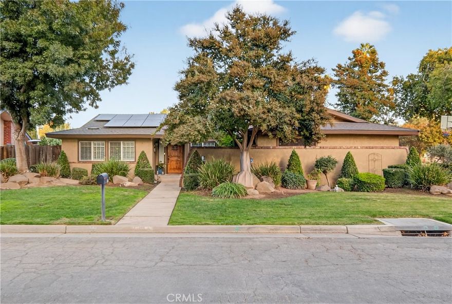Pristine corner lot home located in the heart of Madera's westside. Located on Mainberry's tree lined street, this home offers a touch of modern style in an established neighborhood. You are a short walk away to Starbucks, dining, and Lions Town & Country Park. Step inside to the spacious entryway that instantly makes a statement. Right in time for the holidays, there is a front dining room and den area, ideal for entertaining and enjoyment. Feel at home with spacious living room and a new fireplace insert to stay warm during winter months. There is large tile throughout ideal for foot traffic and staying cool during warmer months. The primary suite offers spacious room with a walk-in closet, and access to the exterior under a large lifetime patio cover. Situated on the eastside of home, this will be the backyard hangout during the summer with lots of space for dining and lounging with no direct sunlight. There is a newer energy efficient pump for the stylish pool.  Stamped concrete makes the low maintenance backyard a breeze to care for. Surrounded by mature bushes and greenery, you will be the envy of family and friends. With cooler and warmer seasons, enjoy the energy efficiency with a brand new solar system that includes Tesla backup batteries. For storage, you have the benefit of a three car garage for your personal use or for all your vehicles. You won't find another home like this on the market, call your Realtor today for a private showing.