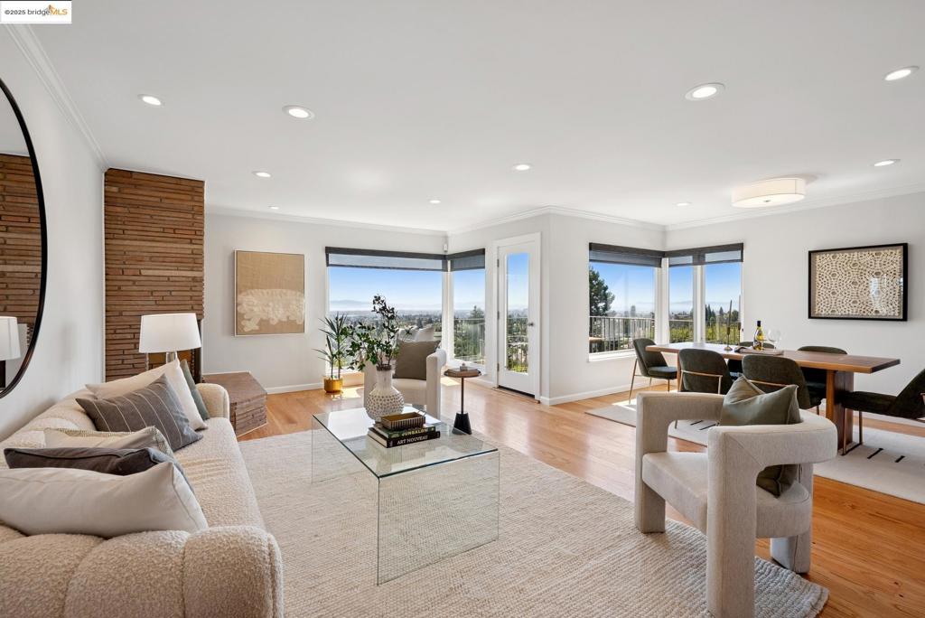 Fabulous & Spacious Level-in 5BR/3BA mid-century gem in coveted Oakmore with jaw-dropping Bay, bridge & city views! Tucked at the end of a serene cul-de-sac, this rare beauty offers no-step entry from both garage & front door. Sunlit main level features 3BR/2BA, a chic living room with floor-to-ceiling windows & mid-century fireplace, open dining with a view, a granite island kitchen with stainless appliances & ample storage. Dreamy view deck off the living/dining area. Downstairs find 2 more bedrooms, full bath, a spacious family room with built-in Tiki Bar & 2nd fireplace, plus workshop/storage space. Outdoors, enjoy a private backyard retreat with patio, fruit trees, grape arbor & hot tub with deck surround. The private front patio is a shaded delight. 2-car garage w/EV charger. Minutes to shops, dining, parks & schools — an entertainer’s paradise with unbeatable views & level-in convenience!