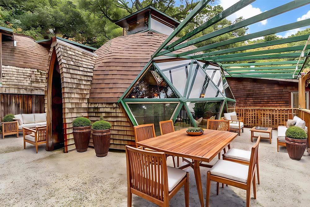 Tucked at the end of a quiet one-lane road, this remarkable geodesic dome home channels the vision of Buckminster Fuller in a stunning architectural statement. Nestled on a private one-acre hillside, it offers panoramic views of Diablo Valley and a true escape into nature. An exceptional Lafayette schools were on the Sellers' minds when they were choosing the Toyon property for their family with two daughters. The dome features recycled wood interiors, skylights, and expansive windows that fill the space with light. Unique touches, such as handmade stained glass, colorful cabinetry, and a custom shingled exterior, add charm and personality. Inside, a dramatic triangular window wall opens to a large deck, and the home features an updated kitchen, spacious bedrooms and baths, as well as both living and family rooms for relaxed, inspired living. In January 2025, during the PG&E power shutoff, Lafayette residents faced days without power. But this home, powered by solar panels and a battery backup, stayed fully functional. "While neighbors relied on flashlights, our lights were on, the fridge running, and our lives uninterrupted." All virtual staging images are created for marketing purposes only. Buyers shall satisfy themselves with a personal examination of the property.