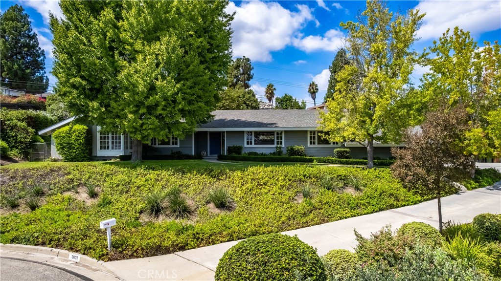 Welcome to this charming ranch-style home in the highly desirable Sunny Hills Estates. Situated on a sprawling over 25,000-square-foot lot, this 4-bedroom, 2.5-bathroom residence offers abundant space both inside and out. A long driveway leads to a 2-car garage, providing plenty of parking and privacy. The backyard is a true retreat, featuring a sparkling pool, a playful swing hanging from a tree, and a dedicated gardening area, perfect for relaxing, entertaining, or enjoying outdoor activities. Inside, the home offers a huge great room with a cozy fireplace and glass sliding doors, ideal for creating flexible living or entertaining spaces. The family room also features a fireplace and French doors that open to the backyard, seamlessly connecting indoor and outdoor living. The kitchen is equipped with a center island, while the adjacent laundry room provides convenient access to the outdoors. The primary suite is a serene escape with ample closet space and an ensuite bath with a dual vanity and tub/shower combo. All additional bedrooms are generously sized and share well-appointed bathrooms. Nestled at the end of a quiet cul-de-sac, this home is just minutes from shopping, freeways, and golf, all within a community filled with mature trees and scenic walking paths. Enjoy the perfect blend of tranquility, functionality, and outdoor enjoyment in Sunny Hills Estates, located in an award-winning school district.
