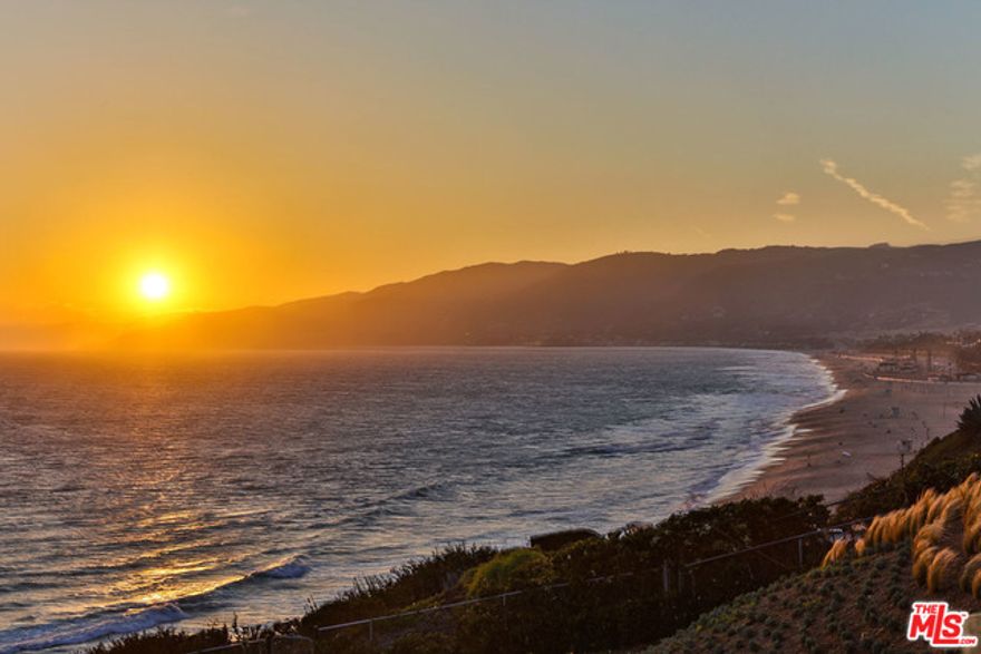 Stately 2-story blufftop estate w/panoramic ocean views. Located on Point Dume, this 6 bdrm/9 ba home, w/2-story GH, has stone, marble & wood flrs, custom ceilings & handcrafted iron/wood detailing. Private/gated, the main house w/ocean views from nearly every rm, offers a 1st floor 2-story entry that flows into a sun-filled sitting rm, formal dining & living rm w/fireplc; gourmet island kitchen w/eating area that's open to family rm w/fireplace; a study/office w/fireplc & bath; & large en-suite bdrm & custom wine rm. A grand staircase leads to the 2nd floor large & luxurious owner's suite w/fireplc, kitchenette sitting rm, 2-spa-like baths, vast closet & triple French doors leading to a sweeping ocean view deck; projection media/family rm w/kitchenette bar; plus 3 additional en-suite bdrms. The 1.2 resort-style acres w/custom fountains, offers multiple-level dining/sitting areas, pool/spa, fire pit, BBQ island, cabana/bar w/full bath & tennis court. 3-car garage w/ample guest parking.