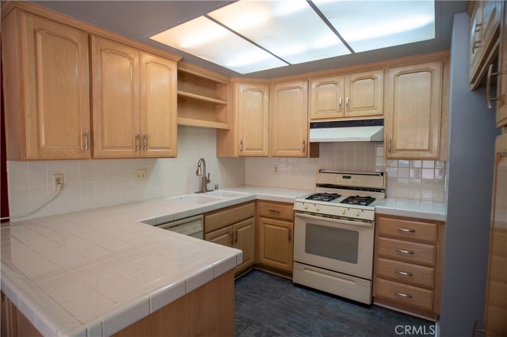 Welcome to this charming Single Story end-unit townhouse in the highly sought-after Glenwood Townhome community of San Dimas! Offering 981 sq ft of living space, this home features three bedrooms and two bathrooms, including a versatile third bedroom that’s ideal as a guest room, office, or den (note: no closet).
The thoughtfully designed kitchen includes custom pull-out drawers and abundant storage, perfect for daily living and entertaining. Laundry is located in the attached two-car garage, which also offers ample built-in storage for added convenience.
Step outside to a spacious covered patio, ideal for relaxing, entertaining, or enjoying the beautiful orange tree just outside your door—a perfect spot for morning coffee or weekend gatherings.
Enjoy a serene lifestyle in a quiet, tree-lined neighborhood filled with lush greenery and mature landscaping. This ideally located unit sits between the community pool and park, with access to tennis and pickleball courts just steps away. Trash bins are housed in a dedicated area between units for easy access and a tidy exterior.
Whether you're looking to settle in or invest, this well-located townhouse offers the perfect balance of comfort, privacy, and community amenities. The home needs some TLC and is priced to sell!