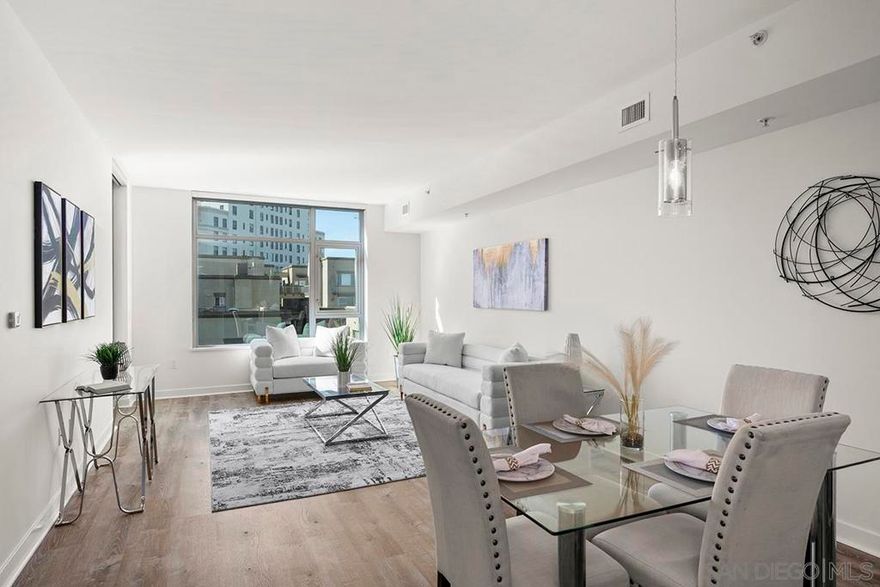 Capture the best of Downtown San Diego living in this 6th-floor, west-facing  Aria residence. Enjoy city views and sunset skies from your private balcony. Inside, this spacious one-bedroom features modern luxury vinyl plank flooring, abundant natural light, and an open layout ideal for both relaxation and entertaining. The kitchen impresses with stainless appliances, recessed lighting, quartz counters and a stylish eat-at bar with a waterfall edge that is perfect for casual dining. The bedroom offers comfort and privacy with an ensuite bathroom and generous closet space. Added conveniences include in-unit stackable washer/dryer and a secured parking space. Perched in the highly sought-after Cortez Hill neighborhood, residents enjoy a serene, residential atmosphere just minutes from Downtown San Diego’s premier dining, shopping, cultural attractions, and the vibrant Gaslamp Quarter. Discover modern luxury living in one of Downtown’s most charming and well-connected communities.  Located atop Cortez Hill, the highest point in San Diego, Aria was completed in 2008 and comprises 137 units. This prime location is set away from the city's hustle and bustle, offering both tranquility and convenience. Residents can enjoy a short stroll or drive to Balboa Park and the vibrant offerings of Downtown San Diego, coupled with excellent freeway access for broader travels. Aria residences boast spacious outdoor balconies and terraces, enhancing the living experience with modern comforts and stunning views of the bay, Balboa Park, and the city skyline. The building's amenities include a fitness center, lap pool and spa, club room with a catering kitchen and wet bar, all designed to elevate the quality of life for its residents.