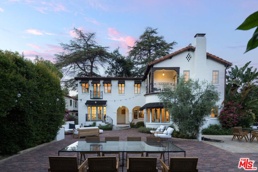 Welcome to The Acacia Mansion, a landmark 1929 Spanish Colonial Revival estate nestled in the heart of Meiners Oaks, Ojai. Situated on an expansive 0.83-acre corner lot, this extraordinary property offers nearly 4,300 square feet of exquisite living space and a rare opportunity to own a piece of Ojai's cultural and architectural legacy.Designated Ventura County Landmark No. 170 and eligible for the Mills Act, this historic residence with Moorish influences and many original details, was originally built for Theosophists David and Madeline Baird, followers of Krishnamurti. Over the years, it has hosted luminaries such as Aldous Huxley, Annie Besant, Marc Chagall. and George Bernard Shaw. Every element of the home reflects its storied past, from the grand pink-marble staircase and hand-carved mahogany doors to gold-leaf ceilings and two original Ernest Batchelder fireplaces. The main residence welcomes you with a breathtaking two-story formal foyer, featuring a filigree wrought-iron staircase, stained glass windows, gold leaf stenciled ceilings, and intricately carved mahogany doors. Elegant formal living and dining rooms, a cozy reading room, and a series of soaring ceilings and arched entryways showcase timeless craftsmanship. Rich hardwood and tile flooring, built-in cabinetry, and graceful balconies with wrought-iron railings evoke the artistry of a bygone era. The chef's kitchen is a culinary delight, outfitted with a La Cornue range, Sub-Zero refrigerator, granite countertops, custom cabinetry, and a walk-in butler's pantry that preserves original architectural details. Upstairs, you'll find five spacious bedrooms and a versatile extra room offering endless possibilities. A detached garage is topped by a private one-bedroom guest apartment with its own entrance- perfect as a secluded retreat or guest quarters. Beyond the interiors, the grounds have been thoughtfully updated and landscaped with mature fruit trees and native drought-tolerant plants. A charming brick patio with an aged fireplace creates a magical setting for gatherings.Recent updates include new HVAC systems, copper gutters, restored exterior plaster, period-style awnings, interior and exterior painting, and enhanced landscaping. The Acacia Mansion is a one-of-a-kind legacy property that offers unmatched character, elegance, and a deep connection to Ojai's spiritual and artistic heritage.