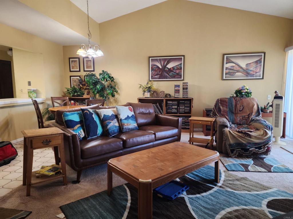 Stylish Top-Corner Condo in Highly Desirable Avocado Village! Welcome to this light-filled, top-floor corner unit in the sought-after community of Avocado Village—just a short walk to popular restaurants, shopping, and more! This beautifully designed condo features soaring vaulted ceilings, abundant natural light, and a spacious open floor plan. Enjoy the convenience of in-unit laundry hookups, your own private patio with sweeping city views, and a cozy fireplace in the living room which is perfect for relaxing evenings. The layout includes 2 spacious bedrooms connected by a Jack-and-Jill bathroom that is thoughtfully designed with two separate vanity areas for added privacy and functionality. Each bedroom features a ceiling fan for year-round comfort. Parking is a breeze with an included one-car garage and an additional reserved parking space. The community also offers a sparkling swimming pool that is ideal for enjoying sunny days in La Mesa. Whether you're a first-time buyer, downsizing, or looking for a fantastic investment, this unit has everything you need in a prime location. Don’t miss your chance to own a piece of Avocado Village!