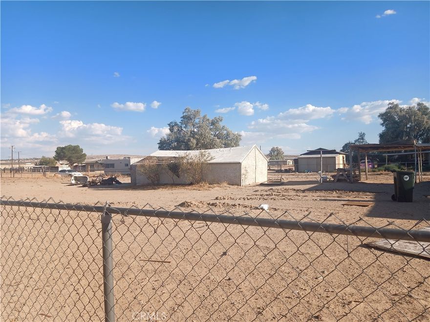 Opportunity awaits on this spacious Level lot that's approximately 1.52 acres of land to build a new residential home. This property is equipped  with essential utilities including a water meter, electric, natural gas providing a strong foundation for future improvements.

Nearly the entire perimeter is enclosed with  chain-link fencing offering security and a defined boundary. It also features a couple of existing outbuildings, for storage or other uses.  behind the remains of a previous home damaged by fire under the former owner.