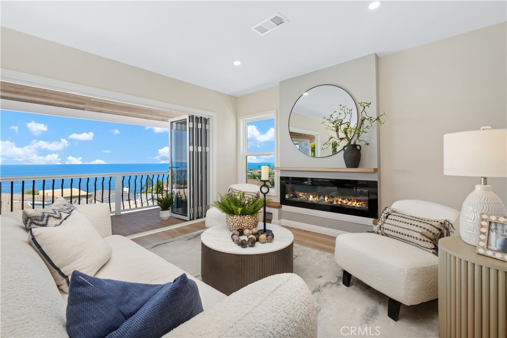 Presenting a two bedroom + office contemporary completely renovated LAGUNA BEACH residence boasting breathtaking panoramic ocean views and three beautiful decks ! This cottage home blends contemporary design with a modern aesthetic, offering a haven of relaxed coastal living at its best. Ideally positioned just moments away from Laguna's renowned beaches such as "Victoria Beach" and the prestigious 5-star Montage Resort. The open floor plan seamlessly integrates the kitchen, dining area, and living room, creating a fluid space that captures the beauty of the Pacific Ocean. Expansive floor-to-ceiling glass sliders lead to an attached ocean view deck, extending the living area and embracing indoor-outdoor living. There are 2 additional outdoor decks with one used for parking for 2 cars on the main level. The gourmet designer kitchen, recently remodeled with new countertops throughout, stainless steel appliances, including a dishwasher, and features a breakfast bar that effortlessly connects to the spacious living room. This charming beach home is a stunning blend of textures and upgrades such as brand new light oak luxury vinyl flooring, sleek light contemporary countertops, and recessed lighting. The residence also boasts modern new windows and doors, ensuring optimal comfort and natural light. The primary bedroom is a serene retreat, offering awe-inspiring ocean views. Both the primary and secondary hallway baths have been recently remodeled and have beautiful finishes, glass shower doors, and new vanities. A cozy secondary bedroom with a private patio adds to the overall allure of this remarkable beach home. Convenience is key, as the property includes in-home laundry complete with a washer and dryer. Garage on main level is used as an office or could be an additional third bedroom. Perfectly situated in close proximity to the Village and the inviting beaches and coves of South Laguna, this residence offers easy access to amenities including renowned restaurants such as the "The Drake" jazz bar steps away, galleries, the local trolley stop, boutique shops, and more. Embrace the epitome of modern coastal living in this exceptional ocean view sanctuary, delivering the finest in Southern California's luxurious lifestyle.