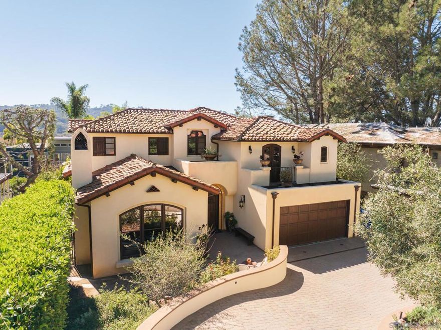 Welcome to 2563 Via Pisa, Del Mar. Tucked along a curved private drive, this Spanish-modern beauty immediately captures attention with its blend of handcrafted tile work, smooth neutral stucco, and a richly stained custom garage door.  Step inside and you’re greeted by abundant natural light and soaring ceilings that open to a grand staircase adorned with custom Spanish tile risers. The front living room is picture-perfect — wrapped in windows, framed with wood-beamed ceilings, and ideal for entertaining or enjoying the morning sun. The adjacent dining room offers generous space and connects seamlessly to a wet bar with abundant storage, creating a perfect setting for gatherings.  The heart of the home lies in the west-facing great room, where a cozy family area opens to a Juliet balcony overlooking the iconic Torrey Pines State Beach. The chef’s kitchen features top-of-the-line appliances, marble countertops, custom cabinetry, and ample seating and prep space. A nearby reading nook leads to the main ocean-view deck — perfect for morning coffee or evening sunsets.  Outdoor living shines here, with a lower patio offering a fireplace, dining area, and multiple seating zones — a California dream for relaxed mornings or starlit dinners.  Back inside, a short flight down reveals a versatile flex room currently used as a wine cellar and fitness area, along with a convenient powder room rounding out the main level.  Upstairs, four bedrooms provide comfort and flexibility. A private guest suite, accessed by its own short staircase, includes a full bath — See Supplement  Upstairs, four bedrooms provide comfort and flexibility. A private guest suite, accessed by its own short staircase, includes a full bath — ideal for visitors or live-in nanny. Two additional guest rooms share a bright Jack-and-Jill bath. The primary suite is a peaceful retreat, filled with natural light and featuring another ocean-view balcony. The ensuite bath includes dual vanities, a soaking tub, glass-enclosed shower, private water closet, and a spacious walk-in closet.  Situated in one of Del Mar’s most desirable enclaves, this home is within walking distance to Torrey Pines State Beach, Bird Rock Coffee Roasters, Buonasera Pizza, and Roberto’s. Enjoy easy access to I-5 and a short drive to the Village of Olde Del Mar.  Craftsmanship, natural light, and sweeping ocean views make 2563 Via Pisa a truly special place to call home.
