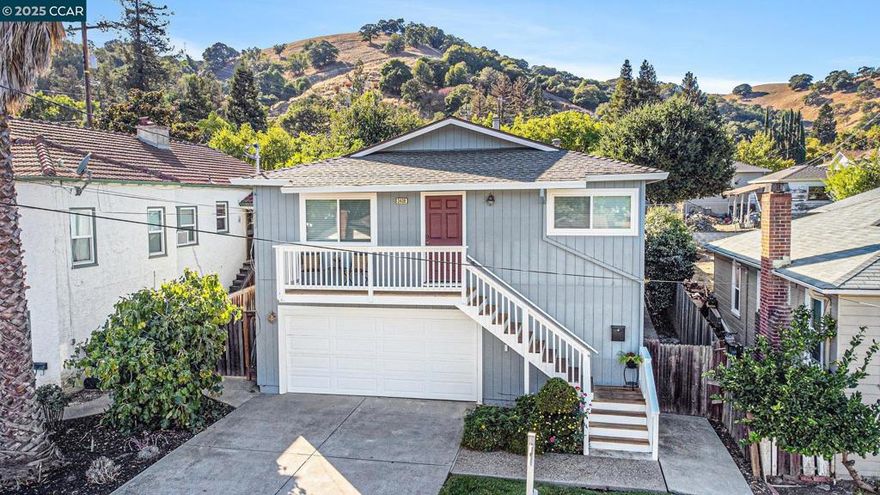 Admired neighborhood near vibrant downtown Martinez!  Spacious living room. Kitchen with white cabinetry, quartz counter tops, tiled backsplash & stainless-steel appliances including refrigerator. OWNED Solar panels (installed in 2024). Fresh interior paint, newer vinyl plank flooring including upgraded baseboards, double pane windows, raised panel interior doors, spacious 2 car garage and central heating & air conditioning. Hall bathroom with newer vanity, sink, faucet, flooring & toilet. Primary bathroom with tiled walk-in shower & flooring, plus newer vanity, sink, faucet & light fixture. Downstairs and included in the square footage (800+/- Square feet) is a huge laundry room/workshop/craft room & two large rooms with many possibilities...family room, game room, office, music room, 2nd unit? (Agent has not verified, buyer to investigate.) Front porch with views of the hills. Backyard is perfect for entertaining with large recently painted deck, stamped concrete patios & hot tub. Conveniently located...minutes to downtown where you can enjoy the Farmer's Market, restaurants, shopping, breweries, coffee houses, the marina, parks, bocce ball, hiking trails & much more. Easy access to highway 4 and 680 and just minutes to Amtrak & BART.  OPEN Sunday 10/12/25 1pm to 4pm.