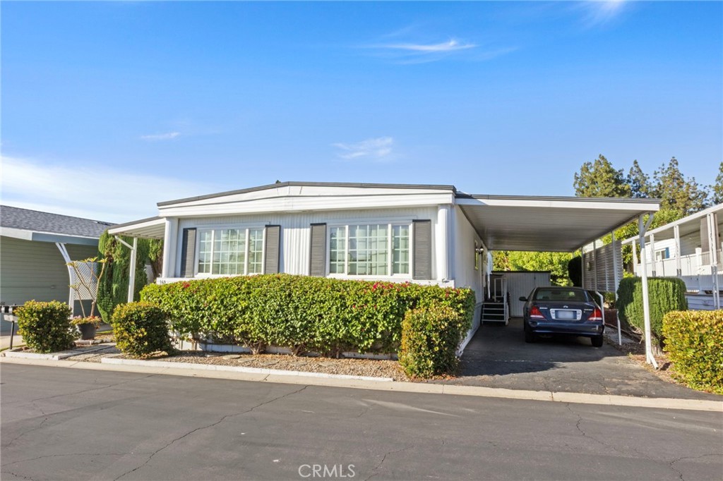 Welcome to Forest Gardens, a beautifully maintained 55+ senior community in the heart of Lake Forest. This spacious double-wide home offers 1,344 sq. ft. of comfortable living space, featuring 2 bedrooms, 2 bathrooms, and an additional den or office area—perfect for working from home or relaxing with a good book. Inside, you'll find carpeted flooring throughout, with tile in the kitchen for easy maintenance. The kitchen opens up to a bright and airy living space, and there’s a dedicated laundry area with washer and dryer hookups for your convenience. Central A/C and heating ensure year-round comfort. Step outside to enjoy your covered carport, a long covered patio ideal for morning coffee or evening relaxation, and an additional private patio space behind the home. This home has been very well maintained and is exceptionally clean, making it move-in ready. As a resident of Forest Gardens, you'll enjoy access to fantastic amenities, including a swimming pool, spa/hot tub, tennis courts, gym, clubhouse, and a recreation room—all designed to enhance your active lifestyle and community connection.