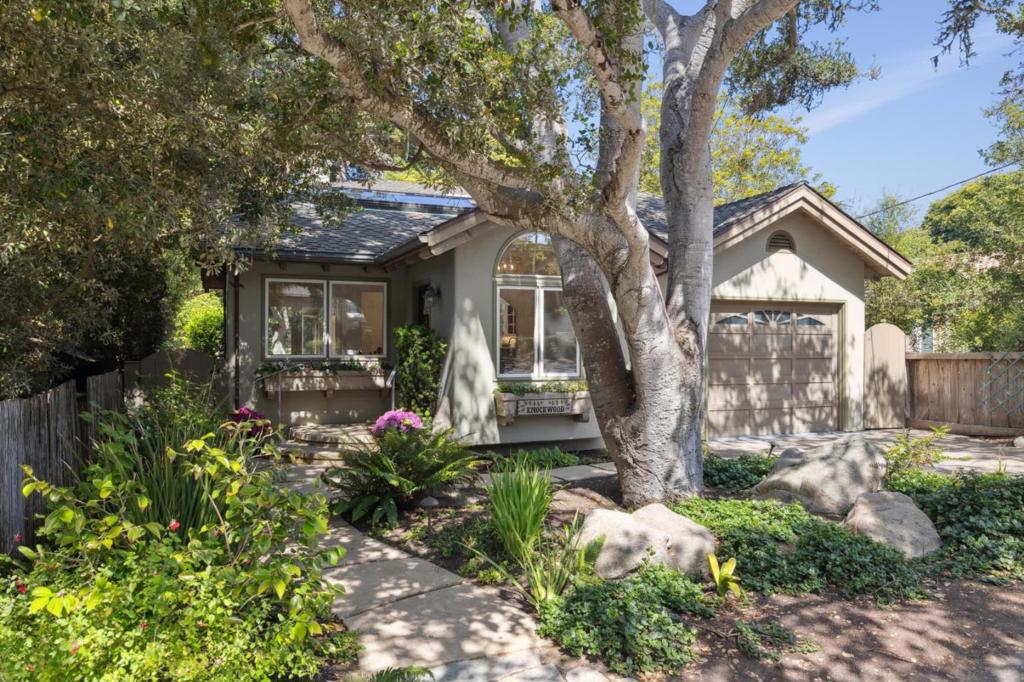 Step into Knockwood, a cherished retreat nestled behind a majestic oak tree in Carmel-by-the-Seas Golden Rectangle. Available for the first time in nearly 30 years, this home is a mere 400 steps from the white sands of Carmel Beach. Enter the living room with high ceilings and ridge skylights, which flood the space with natural light. The open concept design integrates the kitchen with dining and living areas, perfect for entertaining. The kitchen features new leathered Taj Mahal marble countertops, a sit-up bar, and a new sink, stove, and dishwasher. French doors lead to the southern deck, blending indoor elegance with outdoor coastal living. The main-level primary suite offers patio doors, a sitting area, a spacious walk-in closet, and an en-suite bathroom with a Jacuzzi tub, shower, and sauna. Upstairs, discover two bedrooms, one with a fireplace. Both open to a southwestern deck with views of the patio and a large cypress tree. Recent updates include refreshed solid oak floors, new carpeting, fresh interior paint, and a shimmering epoxy garage floor. Situated on the quiet side of the Golden Rectangle, "Knockwood" is perfectly positioned close to the beach and just a short stroll to town. An ideal primary residence or coastal getaway, this is your opportunity in Carmel.