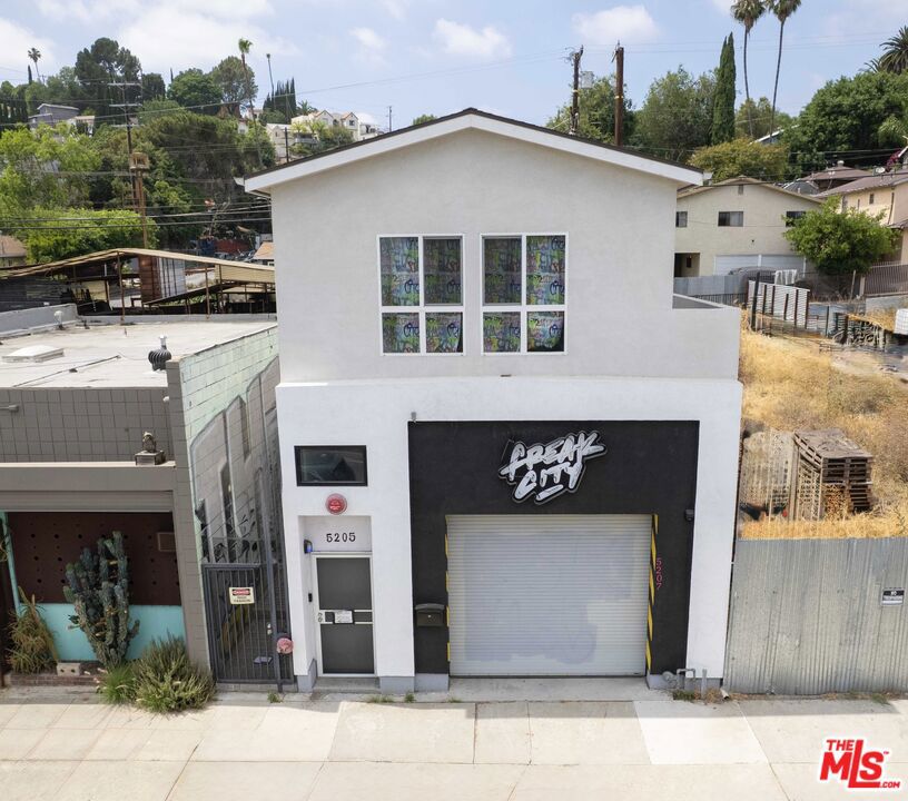 Newer Construction built in 2020 located in the heart of trendy El Sereno, this is the modern live/work gem you've been dreaming of! The street-level features a versatile commercial space ideal for elevating or launching your dream business, studio, gallery, retail storefront, boutique, home office - or simply enjoy the added benefit of rental income. Upstairs, a beautifully designed 2 bed / 2 bath residential unit offers a spacious open-concept layout with contemporary finishes, providing a comfortable and stylish living environment. The thoughtful separation between commercial and residential areas creates a healthy work/life balance, making it the ideal setup for professionals seeking both productivity and leisure time. Set on a secure, gated, and fenced lot, the property includes ample off-street parking, a car lift, and is EV charging ready. Just minutes from Downtown LA, this property is a rare opportunity to thrive in one of Los Angeles' most up-and-coming neighborhoods. Modern architecture. Smart layout. Prime flexibility. Don't miss this unique opportunity to own a home that works as hard as you do.
