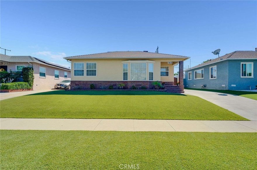 Welcome to this turnkey Lakewood home, where modern updates blend seamlessly with timeless charm. Curb appeal shines with fresh exterior paint, a newer roof, a brick-trimmed porch, and low-maintenance artificial grass. Inside, warm hardwood floors, recessed lighting, and dual-pane windows fill the home with natural light. The inviting living room is highlighted by a cozy electric fireplace and a charming bay window sitting area. A stylish dining nook seamlessly transitions into the updated kitchen, which boasts rich brown cabinetry, a tile backsplash, and a center island with seating. The remodeled bathroom includes a granite vanity, modern fixtures, and a tiled shower with a glass enclosure. Comfortable bedrooms with large closets offer ample storage, while the versatile bonus room—accessible through sliding doors—makes an ideal home office, studio, or playroom. Step outside to an entertainer’s backyard designed for low-maintenance living. The expansive patio provides ample space for outdoor dining and lounging, complemented by artificial turf, a fire pit area, and a storage shed. A long driveway with a private gate leads to a finished two-car garage with TexCote flooring. Additional features include central air and heat, ceiling fans, custom baseboards, updated electrical systems, an inside laundry area, and energy-efficient upgrades, such as a whole-house fan with two solar-powered vent fans. Gompers and Bancroft Schools are in this home's borders. You are close to the San Gabriel River Bike Path, Monte Verde Nature Trail, and San Martin Park (also known as Pumpkin Park). Truly move-in ready, this home combines comfort, style, and functionality inside and out.