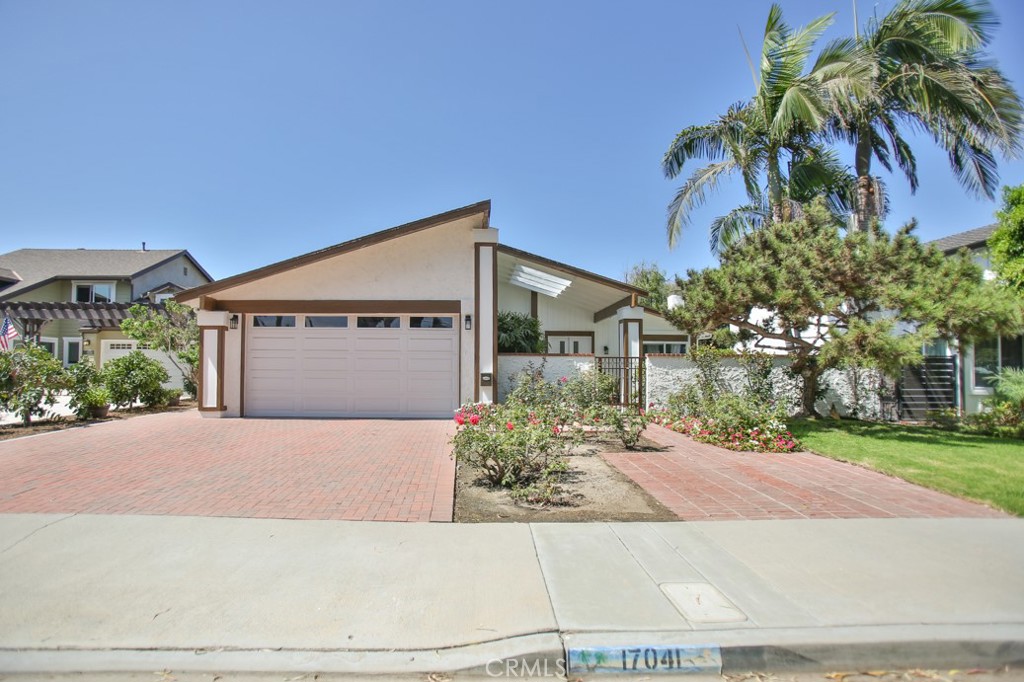 Welcome to your beautifully renovated Huntington Harbour home! This modern, contemporary residence has been thoughtfully redesigned with meticulous attention to detail and is truly move-in ready. This spacious single-story home offers 4 bedrooms and 2 baths across over 1,700 sq ft of living space. Nestled on a generous 7,500 sq ft lot in a serene cul-de-sac, the property ensures privacy and room to grow, with potential for ADU expansion. As you enter the private gated courtyard, you'll immediately experience a sense of tranquility and seclusion. The open-concept great room, featuring high ceilings and a single-level layout, epitomizes effortless California Coastal living. The upgraded kitchen boasts custom European-style glossy white cabinetry, high-end stainless steel Bosch 800 series appliances including a four-door French-style refrigerator, drawer microwave, and electric stove, sleek quartz countertops, and a stunning glass mosaic backsplash—ideal for gourmet cooking and entertaining. The home also includes a newly installed custom bar and cabinets with an integrated wine/beer fridge, complemented by LED lighting. The property features a vast, meticulously manicured backyard with two new remote-controlled/switch awnings, perfect for outdoor entertaining. The epoxy-finished garage floor and paver driveway with brickwork enhance functionality and curb appeal. Additional upgrades include fully paid-off solar panels, fumigation, a luxurious porcelain tile fireplace with an onyx look, high-quality 12mm waterproof wood flooring, fresh paint inside and out, blending style with energy efficiency. Located in the highly sought-after Huntington Harbour community, you'll enjoy access to multiple marinas and waterways for boating and water sports, and nearby “Little” Beach and parks. The Huntington Harbour Mall offers fantastic shopping and dining options. Make this exceptional property your new home!
