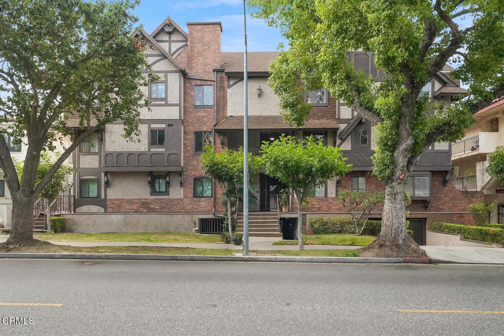 Charming Tudor-Style Glendale Condo - Rare 3-Bedroom, 2-Bath with Elevator Access.This freshly painted 3-bedroom, 2-bath condo offers comfort, convenience, and a functional floor plan. Located on the second floor with elevator access directly from the parking garage, it's designed for easy living.The inviting living room opens to a private balcony, while the layout includes both a formal dining area and a breakfast nook, plus a small bar perfect for entertaining.The kitchen provides ample cabinet and counter space, while the bathrooms--though not recently updated--are clean, well-kept, and nicely maintained. The spacious primary suite includes a walk-in closet, and the secondary bedrooms are flexible for family, guests, or a home office.Additional highlights include rich wood flooring in the main living areas, in-unit laundry, plenty of storage, and a dog-friendly community. Ideally located just half a mile from The Americana at Brand and the Glendale Galleria, this home also offers convenient access to shopping, dining, and transportation.A wonderful opportunity to own a spacious home in a desirable Glendale location--ready for you to move in and make it your own!