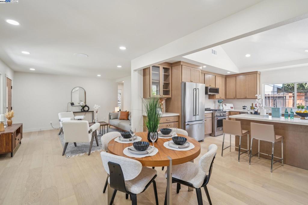 Beautifully remodeled home on a spacious corner lot in Pleasant Hill’s desirable Gregory Gardens neighborhood. This light-filled residence features an open layout with engineered hardwood floors, newly renovated bathrooms, and a stunning vaulted-ceiling kitchen equipped with KitchenAid stainless steel appliances and custom Schrock cabinetry with stained maple wood doors and finishes. Thoughtfully upgraded throughout with a new HVAC system, tankless water heater, 200 AMP main panel, updated wiring, new windows, exterior doors, stucco, and texture. The garage has been converted into a permitted JADU, offering flexible living or rental potential—all in a charming, tree-lined community.