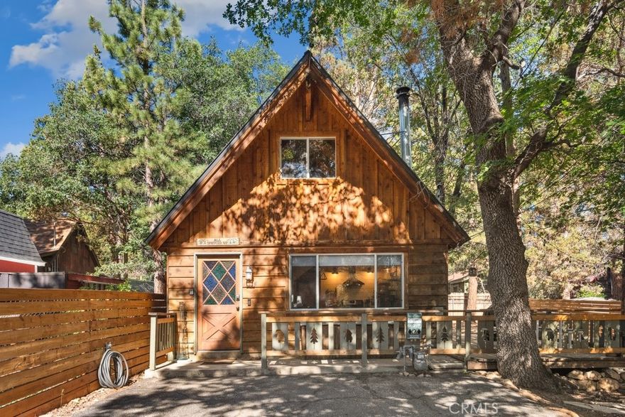 Charming Sugarloaf Cabin Chalet on a Spacious Lot. Tucked among towering pines, this charming Sugarloaf chalet-style cabin offers rustic elegance with modern comforts. Sitting on an expansive fully fenced and gated lot, the home features a large parking pad, spacious deck, and a cozy firepit area—perfect for relaxing, BBQs, and year-round enjoyment. Go inside to soaring vaulted pine and beamed ceilings, an open floorplan, and a welcoming living room with a high-efficiency wood stove. The updated kitchen shines with butcher block countertops, stainless steel appliances, peninsula bar seating, and open shelving, making entertaining easy and stylish. The main level includes a bedroom and a beautifully updated bathroom featuring heated tile floors, a natural stone vessel sink, and a custom vanity. Upstairs, a spacious loft-style bedroom offers additional comfort and charm. Flooring includes durable wood-look tile and carpeted bedrooms. Enjoy peace of mind with upgrades like a newer insulated roof (2016) and dual-pane windows. A storage shed, patio, and ample outdoor space complete this mountain getaway. Ideally located just minutes from Kallan’s Bar & Grill, the general store, local parks, and schools—this home is ready for your next adventure or full-time mountain living.