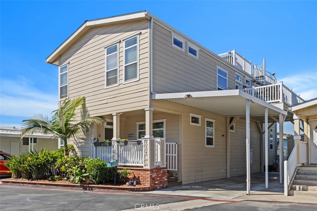 Coastal Elegance in Surf City Beach Cottages, just steps from the sand. Nestled on a quiet cul-de-sac, this residence blends modern design with the relaxed ease of coastal living. Homes of this type and size are rarely available in Orange County, and this one has never before been offered to the public, making it an exceptional opportunity in a highly sought-after location. Its setting offers the perfect mix of comfort and convenience, just minutes from the beach, Huntington Beach Pier, and Pacific City. Inside, soaring ceilings and an open floor plan create a seamless connection between the living, dining, and kitchen areas, ideal for both everyday living and entertaining. The kitchen is designed for the entertainer and the everyday user, featuring granite countertops, a spacious island, recessed lighting, custom cabinetry, and stainless steel appliances, including a new double oven. Three en-suite bedrooms, including a downstairs suite perfect for guests or multigenerational living, are complemented by an upstairs office that can easily serve as a fourth bedroom. With three full bathrooms and two half baths, the layout is as functional as it is stylish. Upstairs, a private rooftop deck captures sweeping views, the perfect backdrop for morning coffee, sunset gatherings, or Fourth of July fireworks. A covered two-car carport with room for a third vehicle, a welcoming front porch, and access to community amenities including a pool, spa, and clubhouse further enhance the lifestyle. Recent upgrades such as some updated windows, fresh paint, and updated ceiling fans add to the home’s comfort and appeal. Living here is more than owning a home, it’s about embracing the Surf City lifestyle, where golden beaches, local dining, and lively events are just a short stroll away. Whether as a primary residence or a second beach retreat, this home offers the space and flexibility to fit every need and occasion. Don’t miss this rare chance to claim your piece of Huntington Beach paradise, where comfort, convenience, and coastal charm meet.